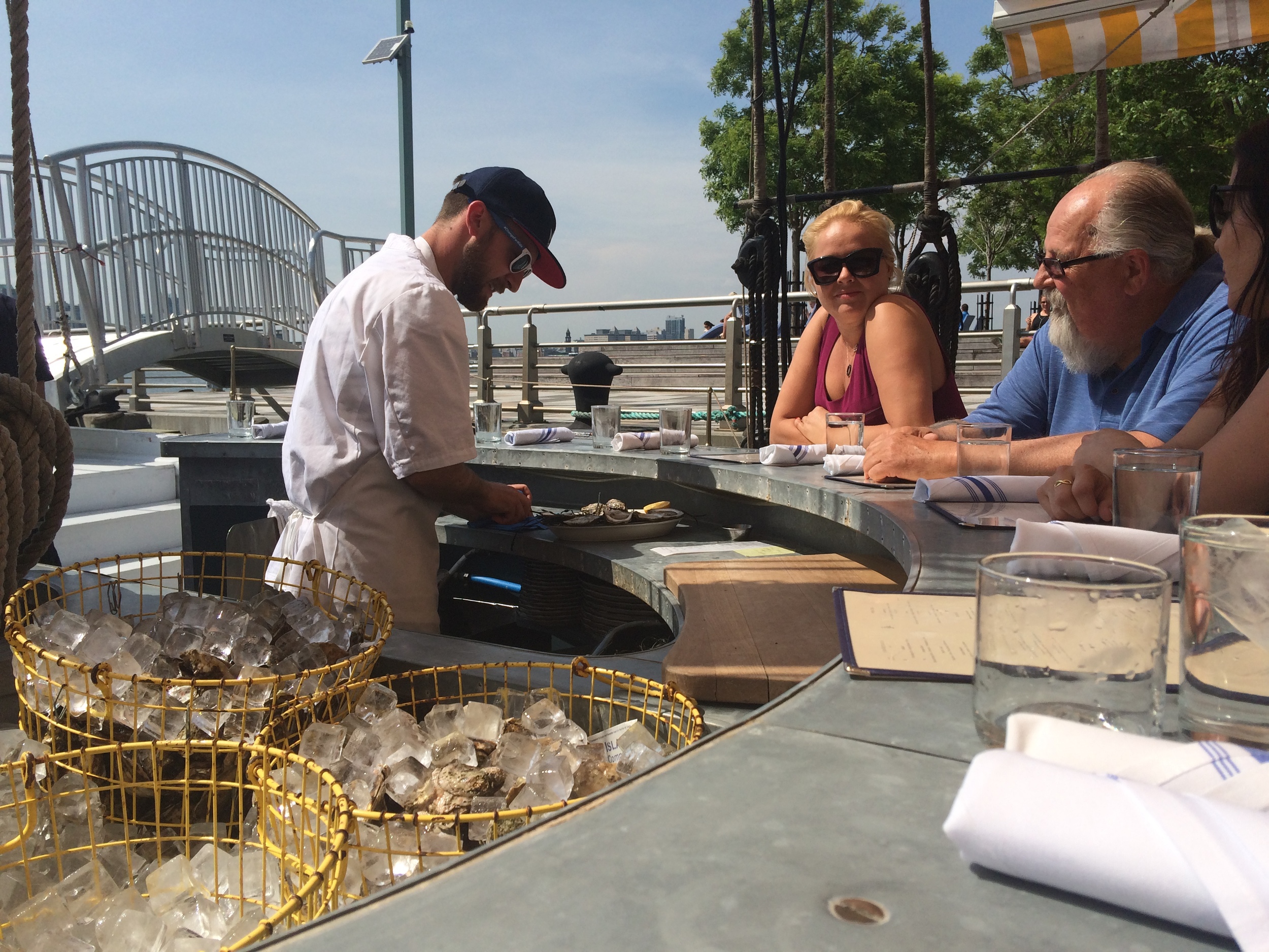 Oysters are shucked to order by a cook behind the raw bar.