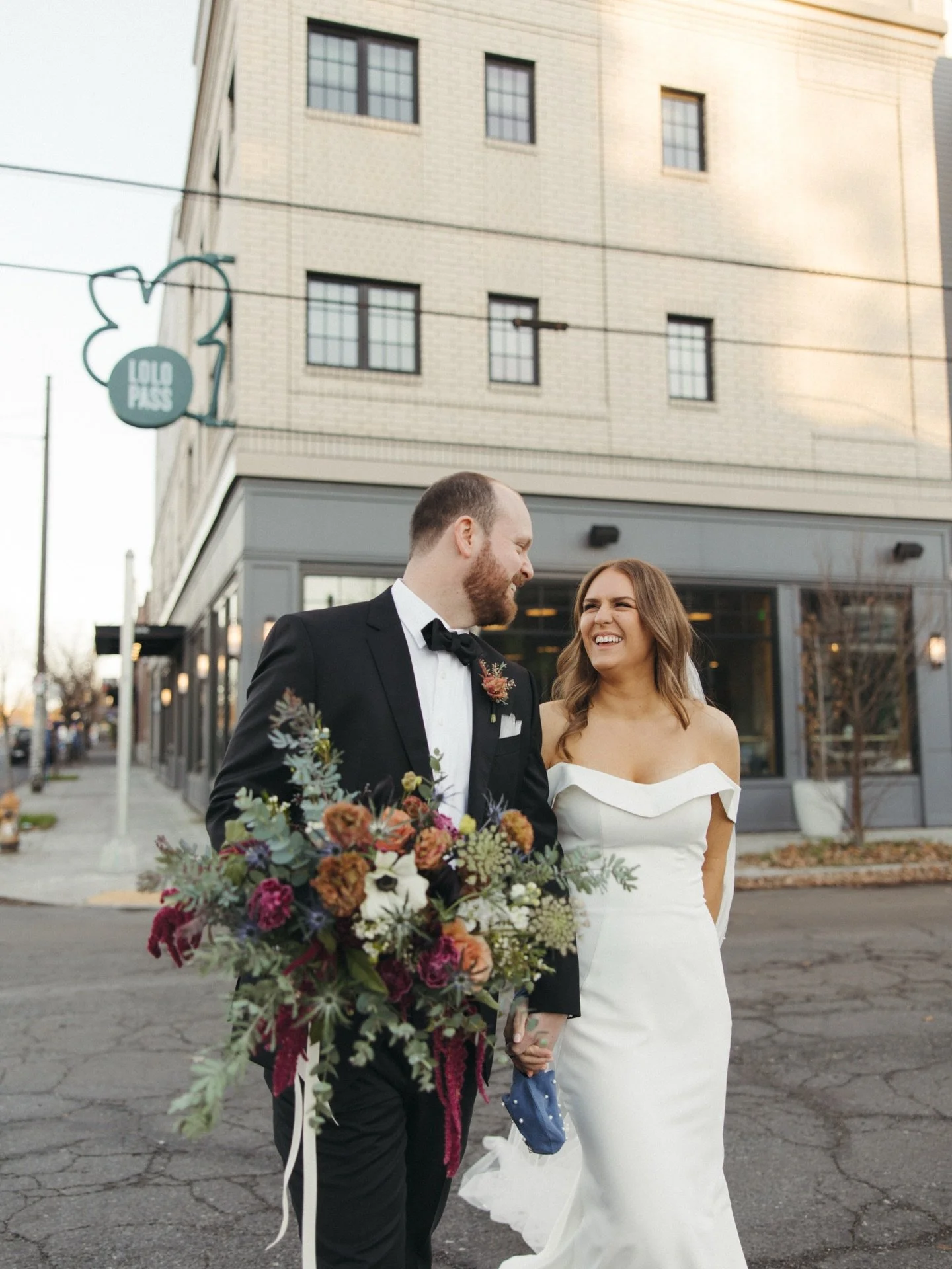 You&rsquo;d never guess this photo was taken on a brisk winter wedding day! 

Also, kudos to the groom, holding that bouquet just so - exactly where I wanted eyes to land. 

Lastly, I love how the blue thistle in the bouquet is matching the brides cl