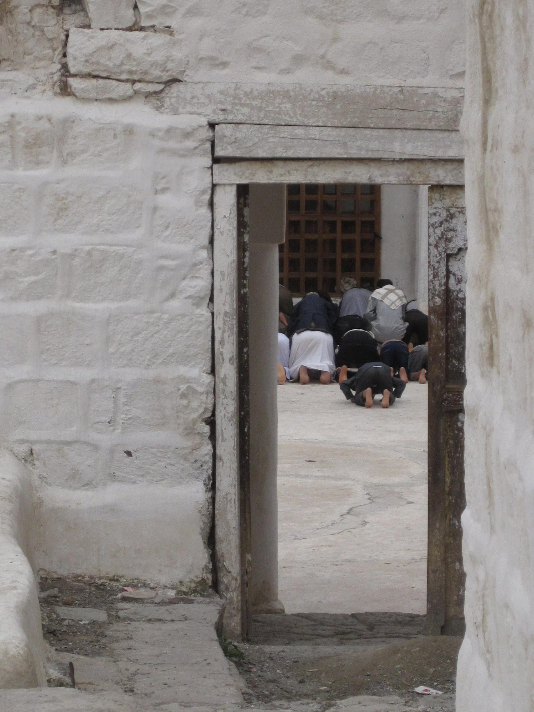 Men praying at the old mosque of Jibla