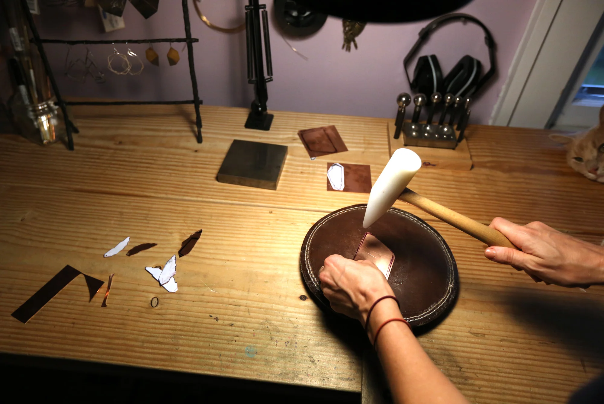 Forming the copper with a plastic mallet on a sandbag.