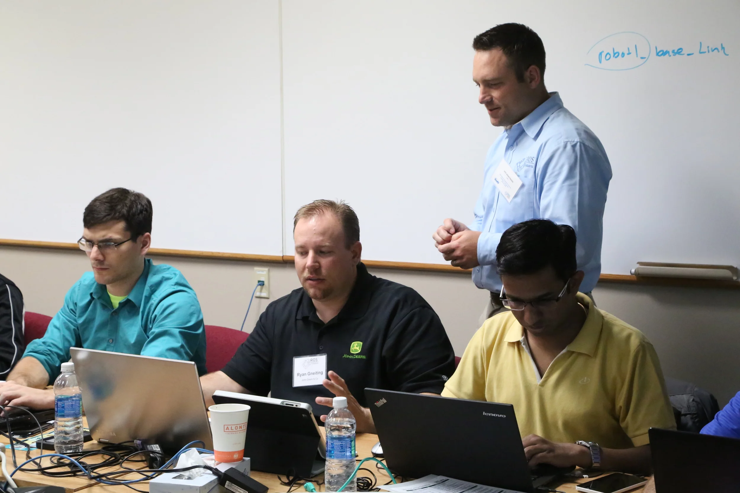 all students bring their own laptops with a virtual machine that is set up and ready to go; levi approaches a student with a question