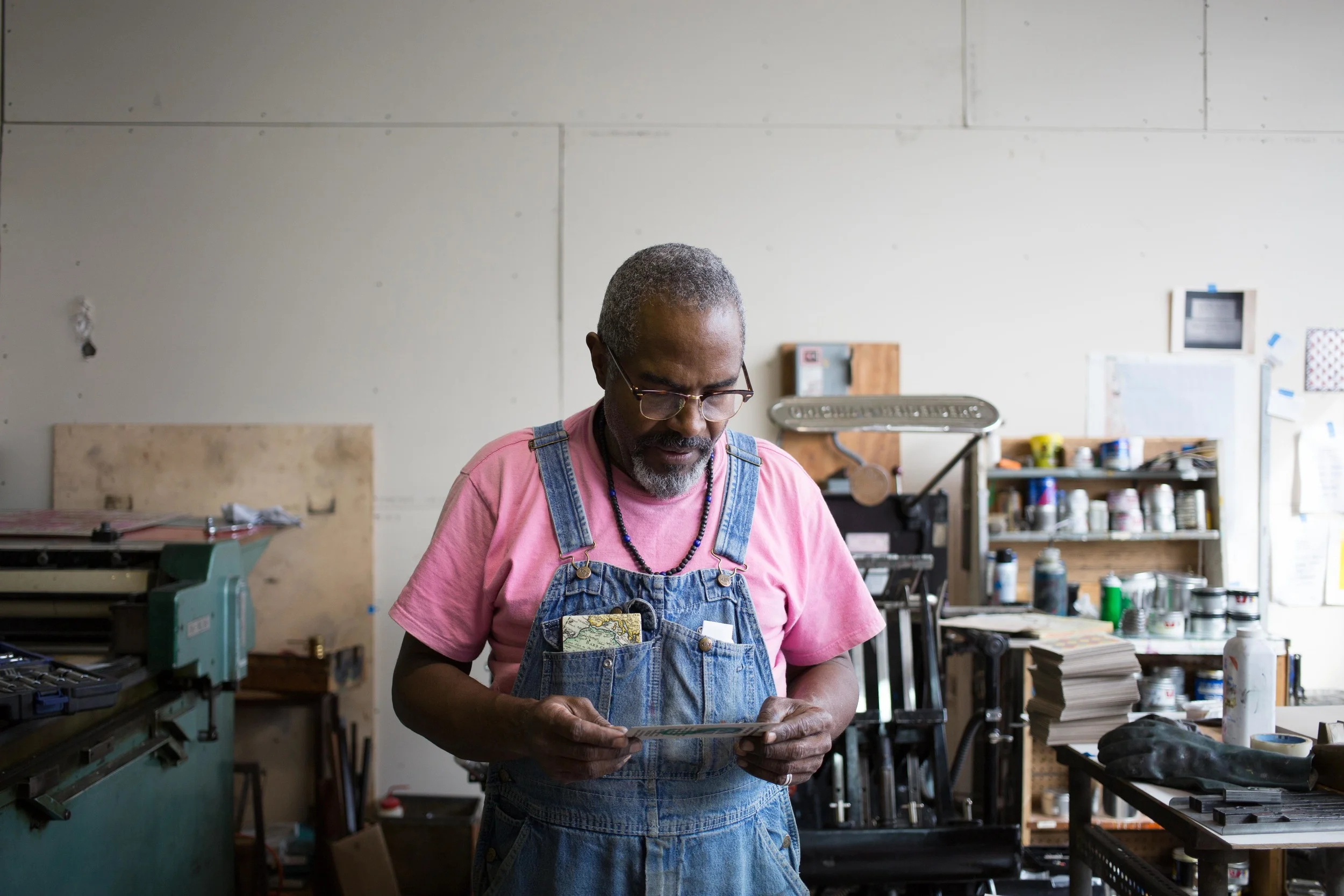 Amos Kennedy in his studio reviewing a test print.