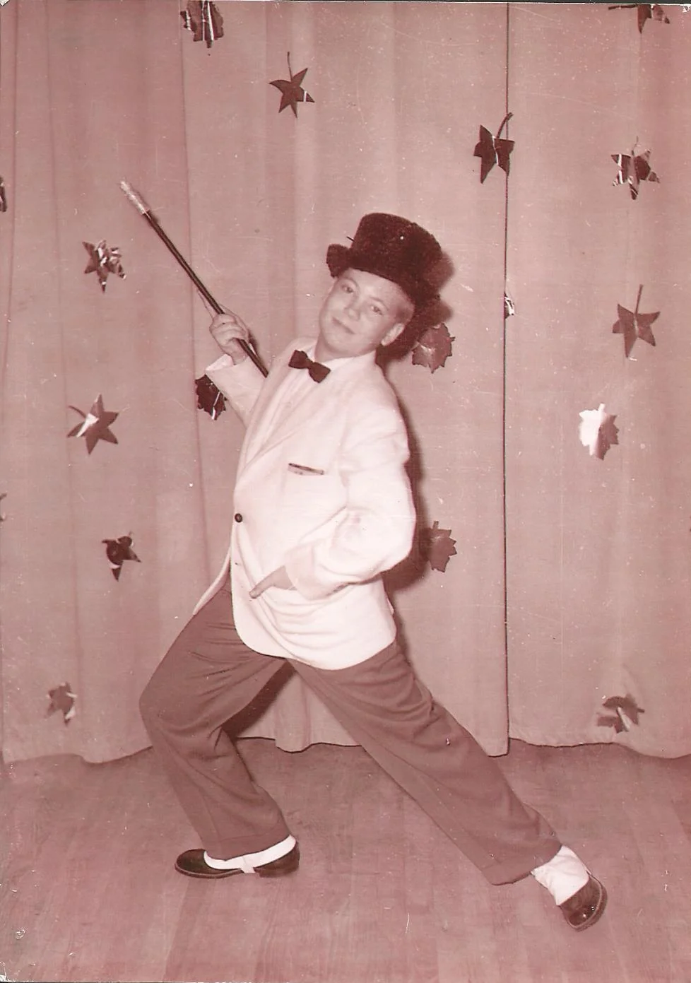 My father looking dapper as he tap dances to "Putting on the Ritz" at his high school talent show.
