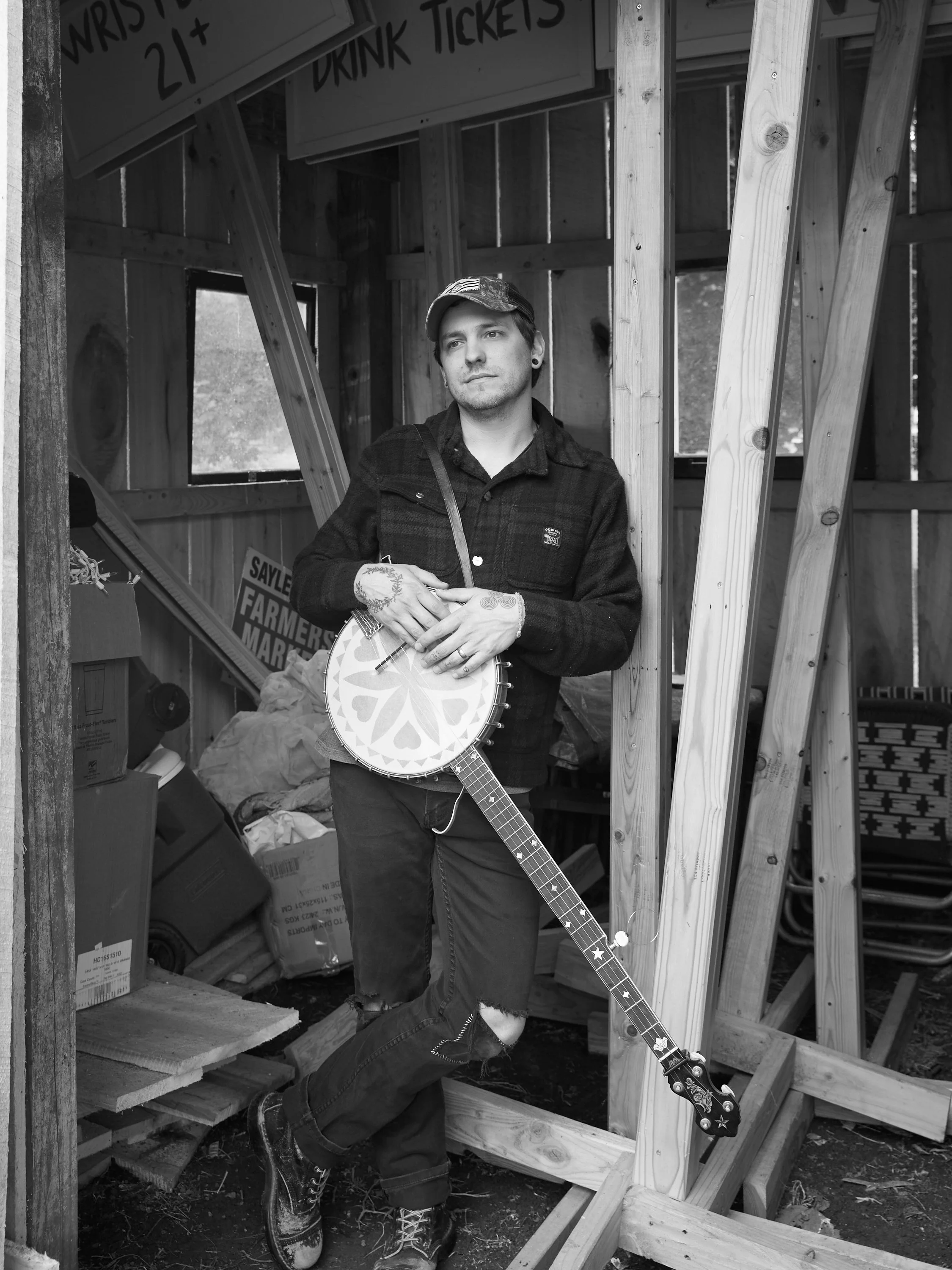 A photograph of a person holding a banjo.
