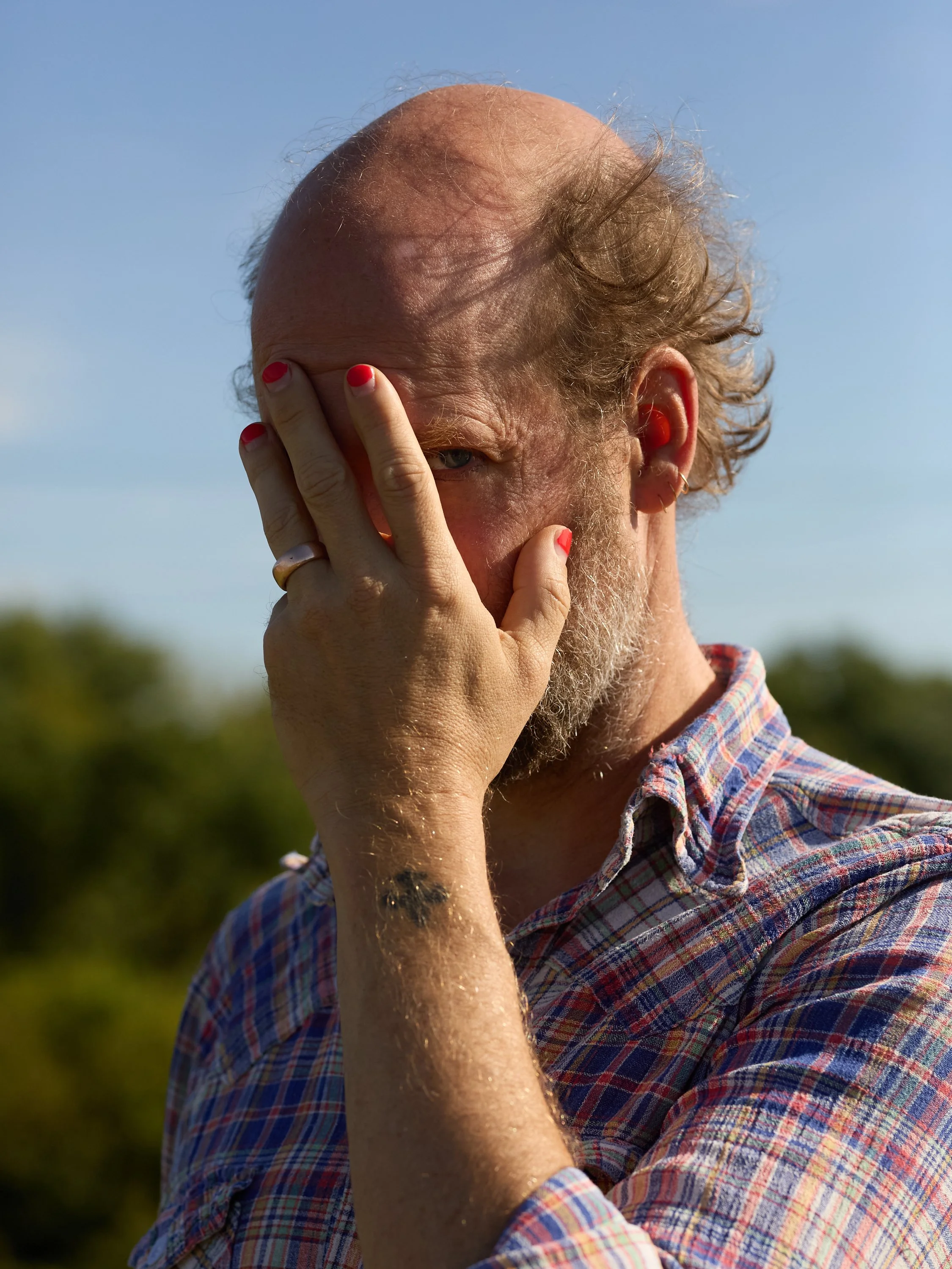 A person covers their face.