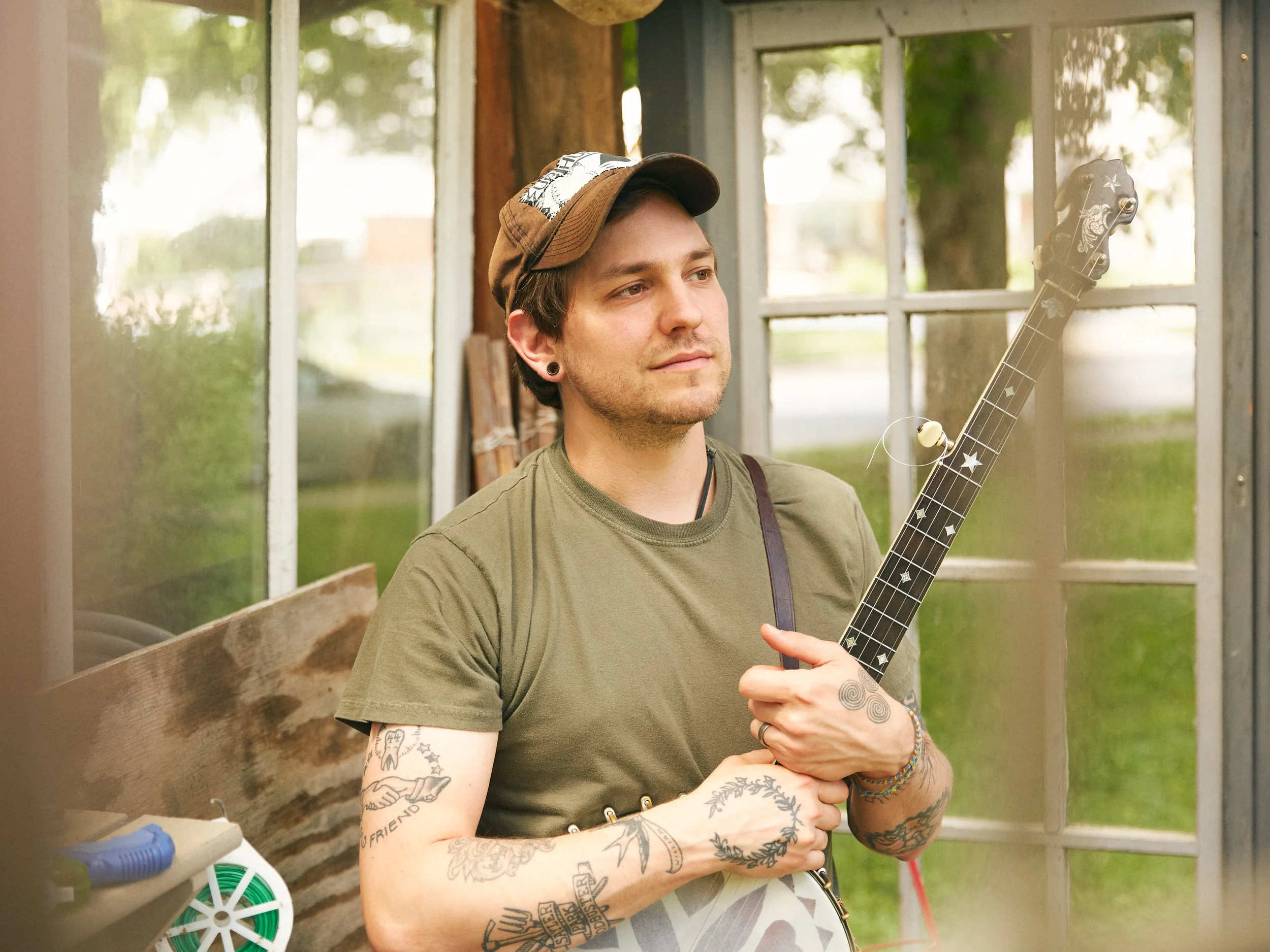 A photograph of a person holding a banjo.