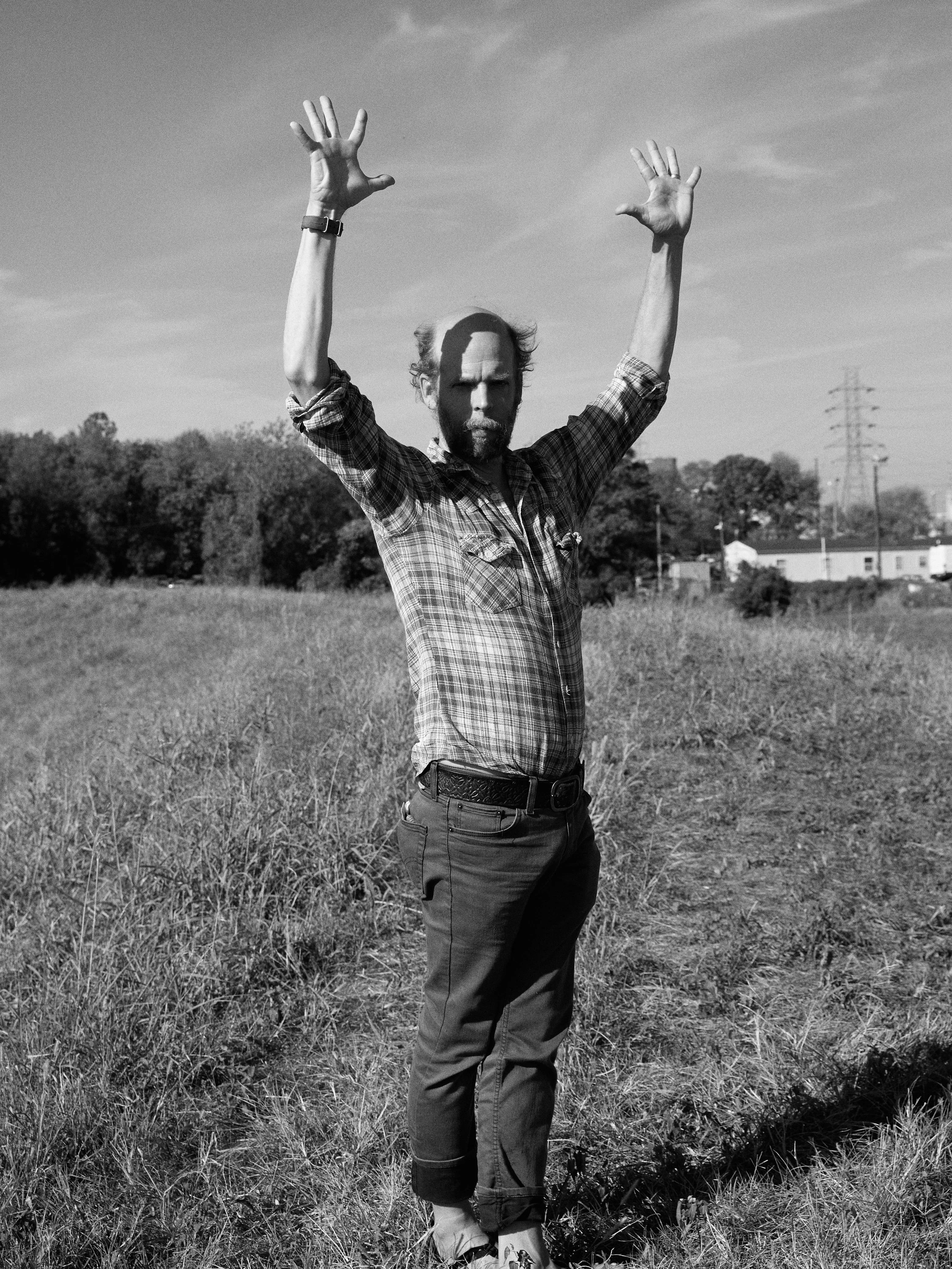 A person standing in a grassy field.