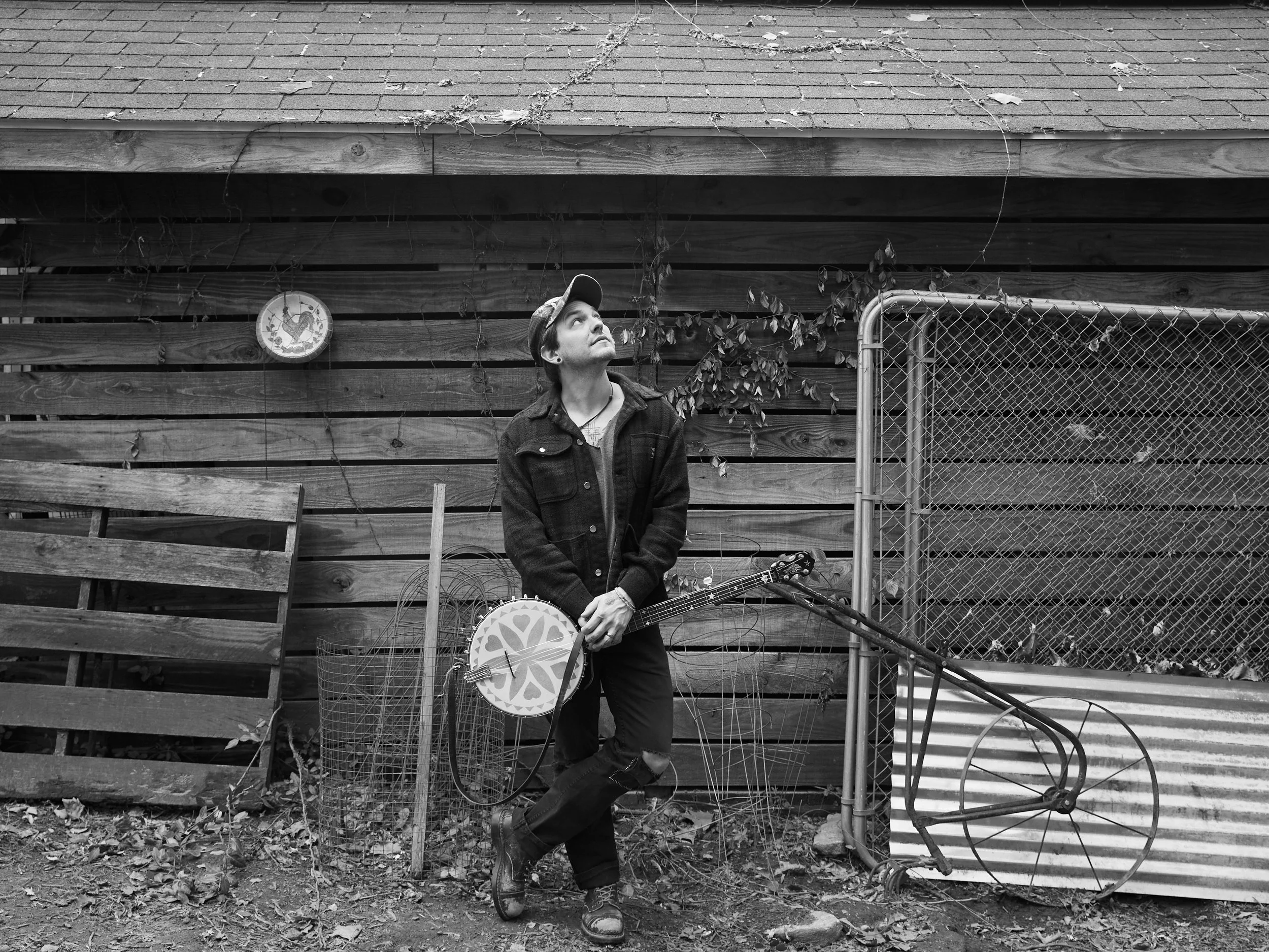 A photograph of a person holding a banjo.