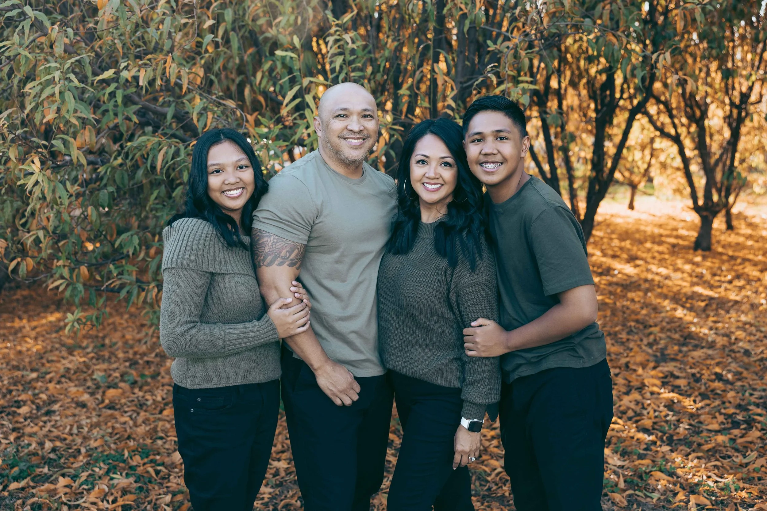 Whole Batoon family looking at camera in Agritopia orchard
