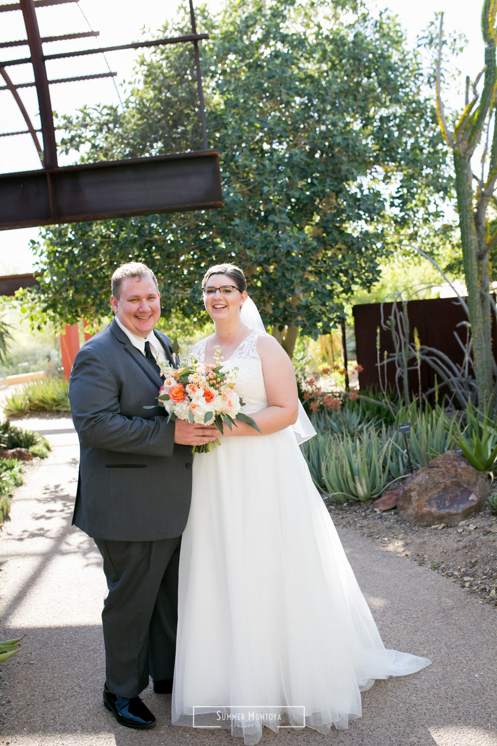  Bride and groom smiling at their Phoenix wedding at the Desert Botanical Gardens 