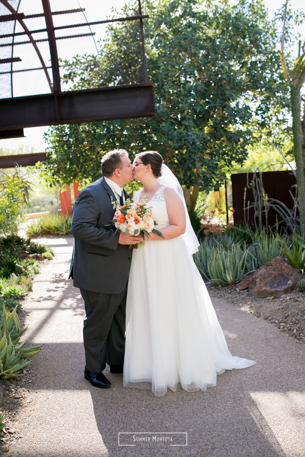  Bride and groom kissing at their Phoenix wedding at the Desert Botanical Gardens 
