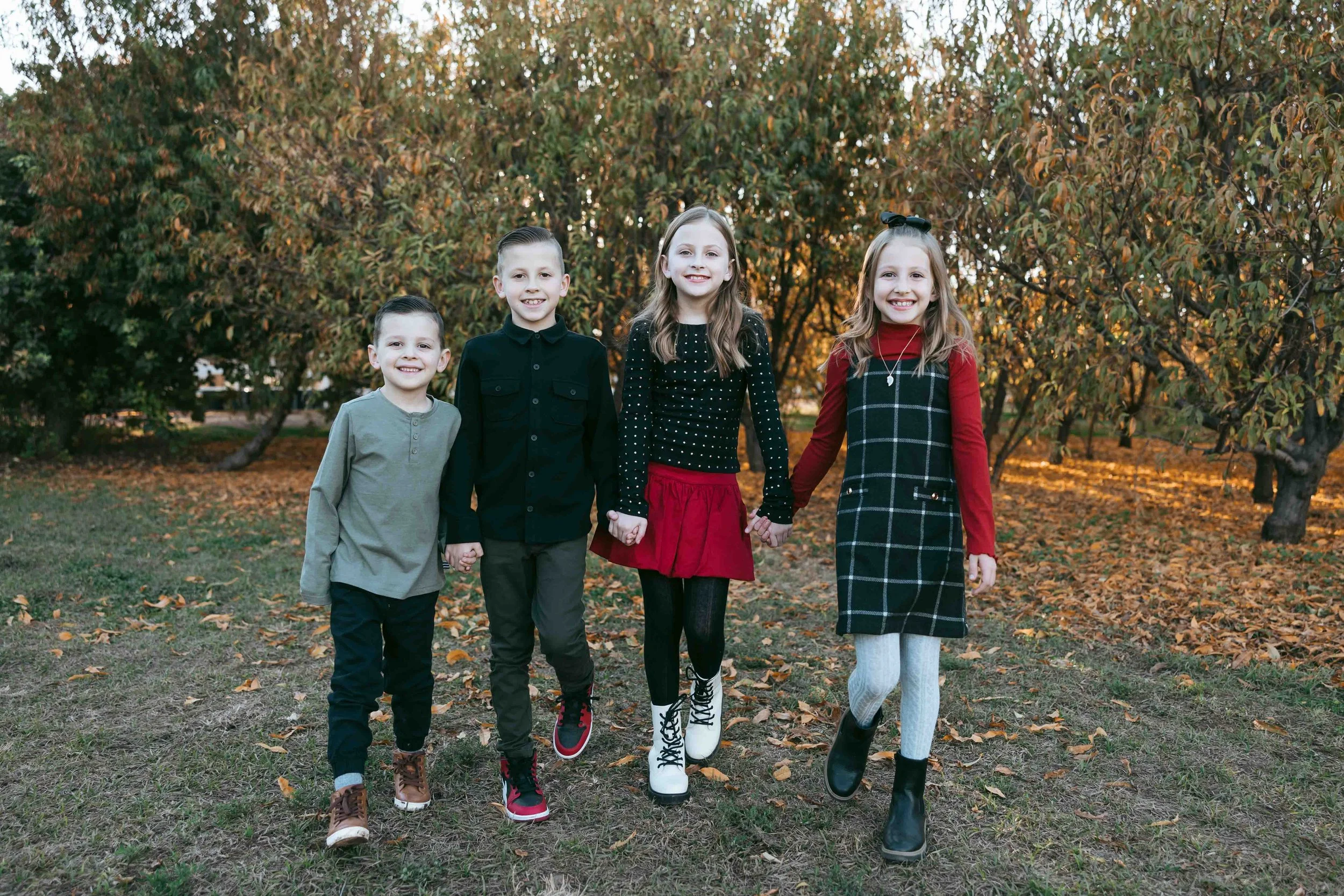 Kids running through Gilbert orchard during family photo session