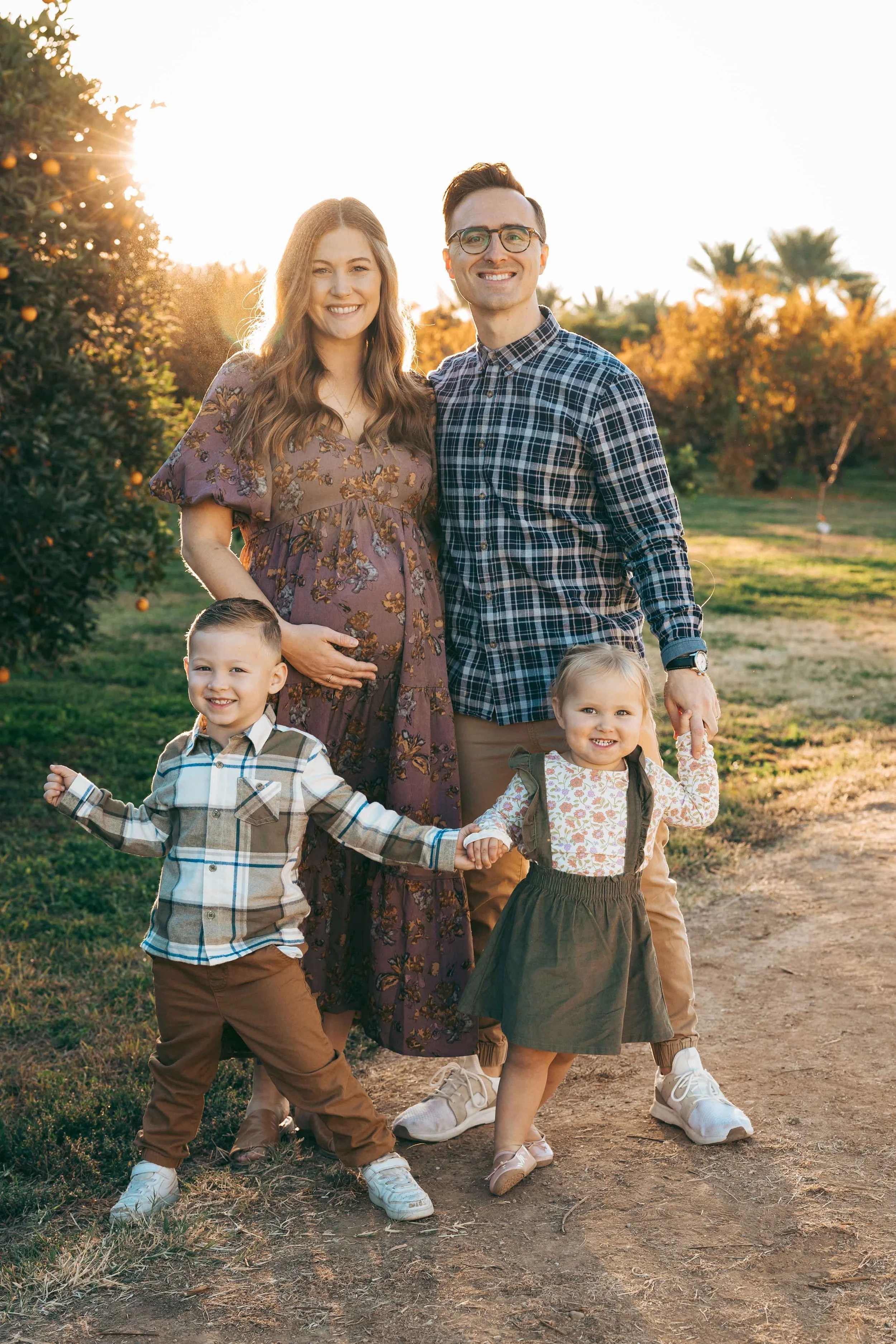 Family photography session at Agritopia Orchard in Gilbert with playful toddlers and fall trees