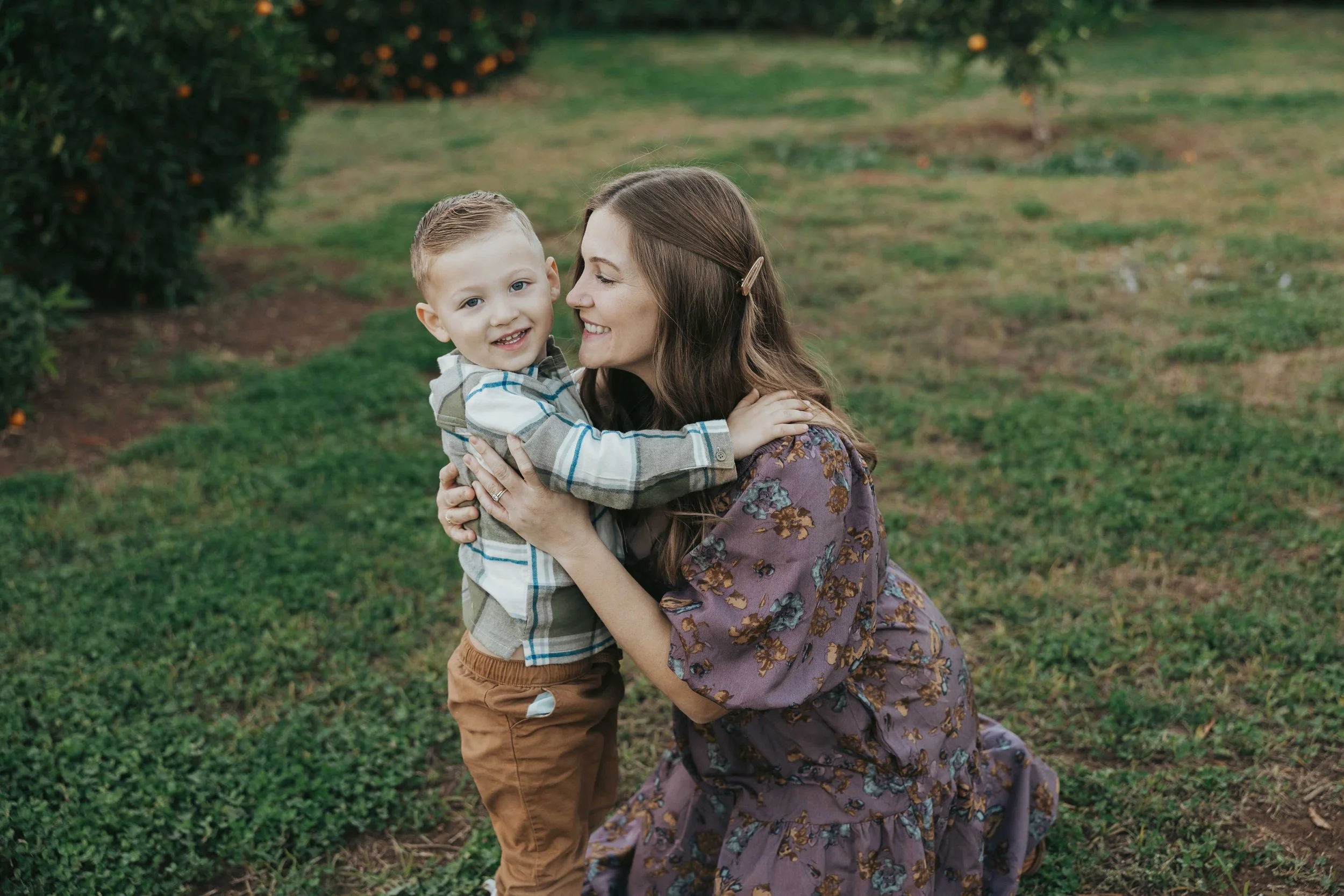 Mom and young daughter hugging in Agritopia Orchard in Gilbert