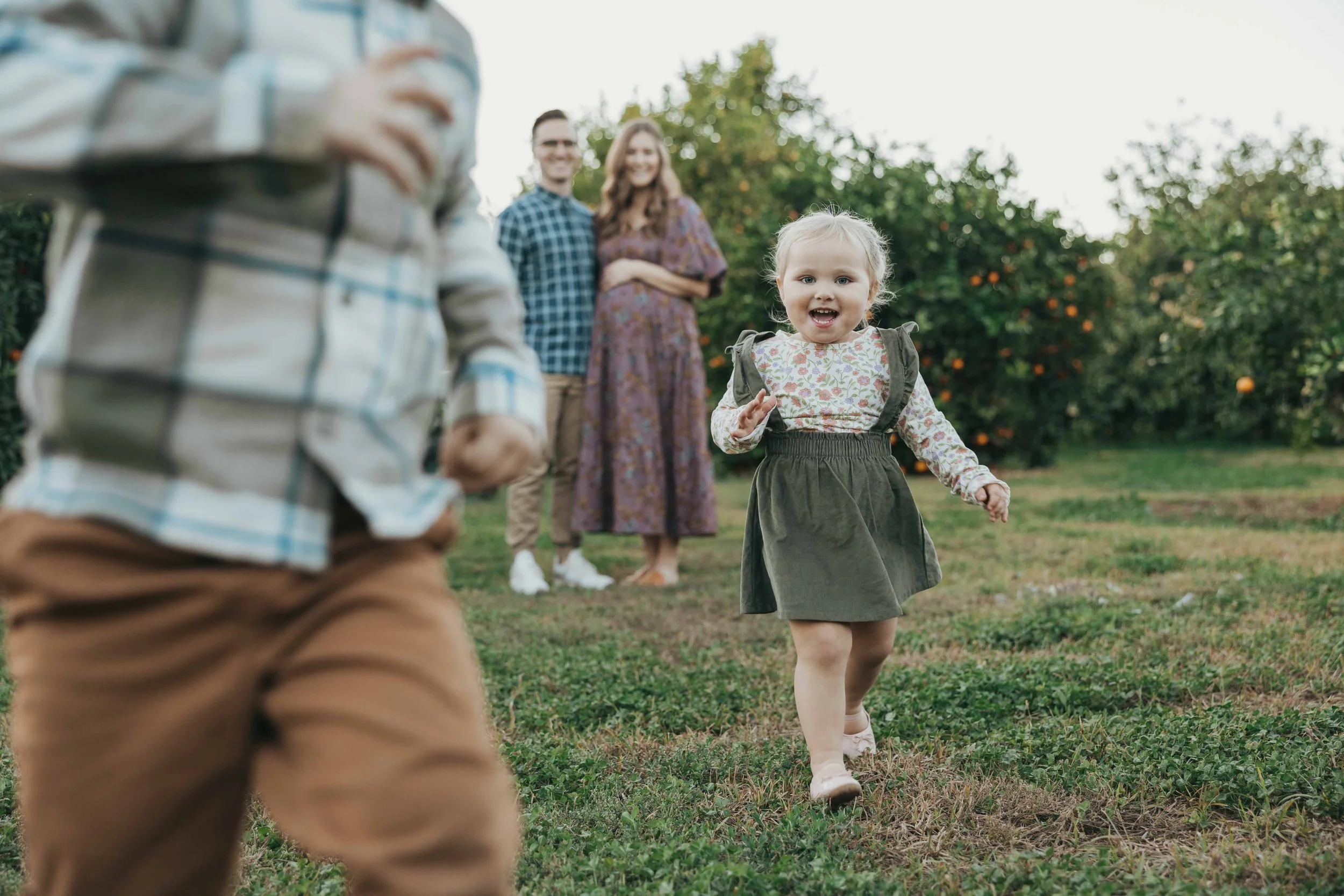 Candid family photo of parents playing with their toddlers during a Gilbert family session