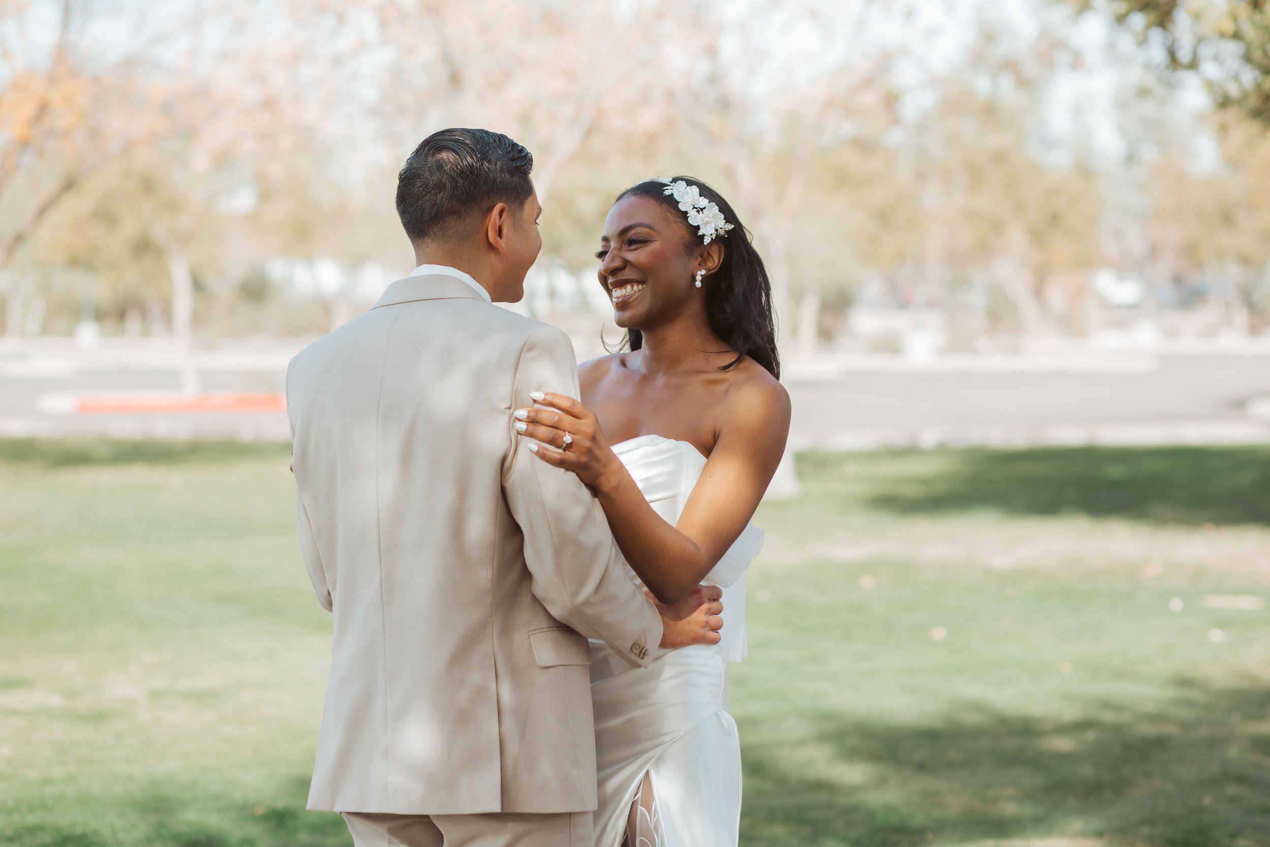 Jade and Abel laughing together during their first look on their wedding day