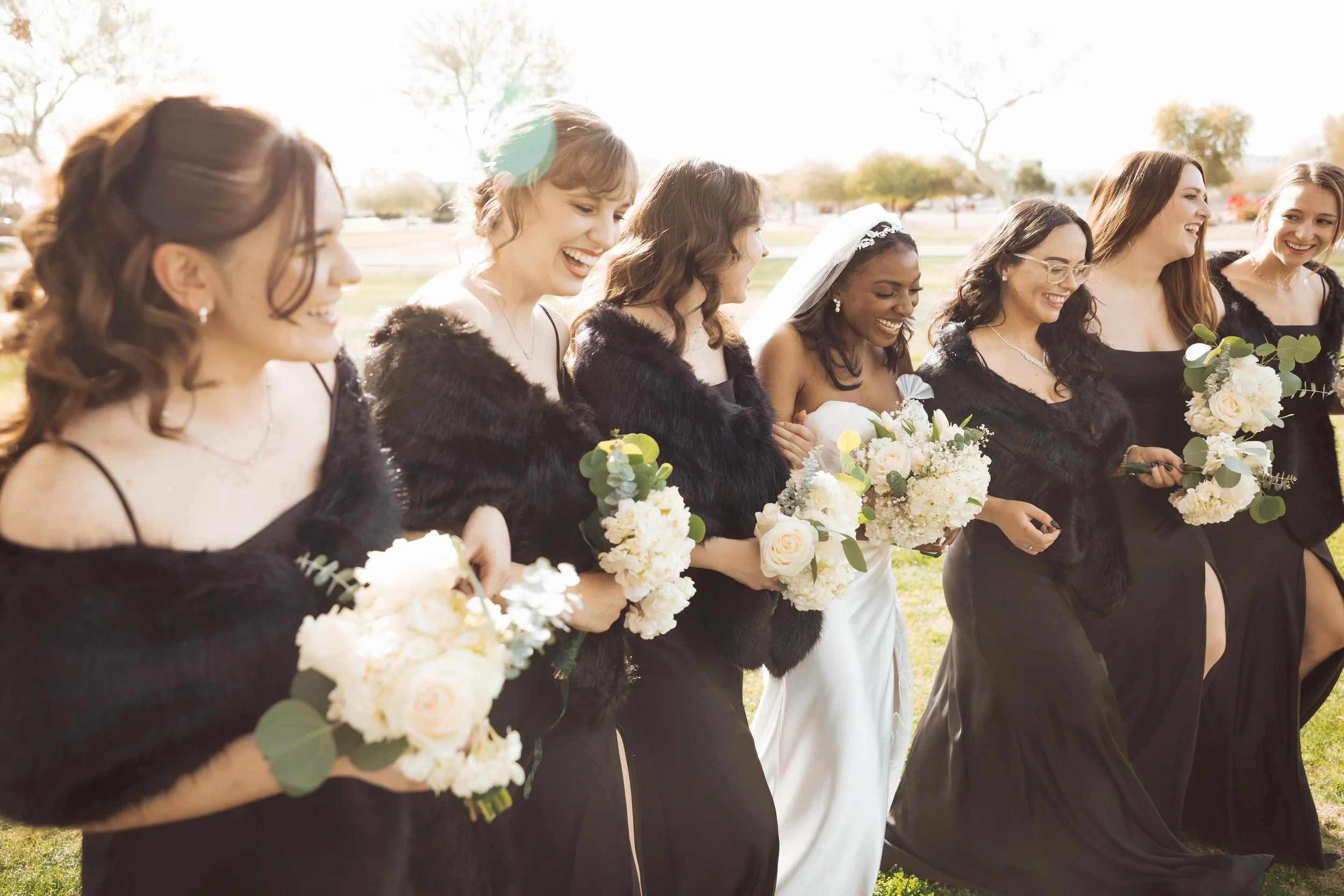 Bridesmaids laughing together during wedding party photos in Gilbert