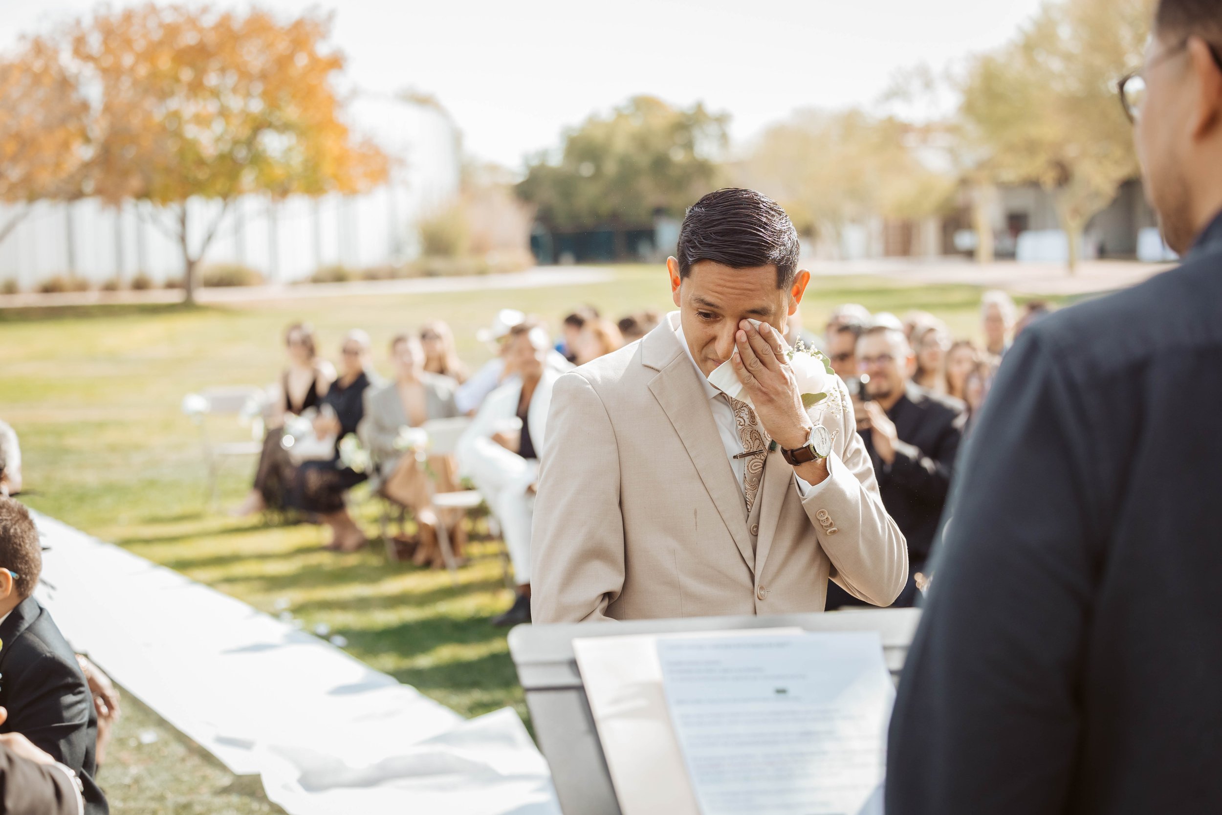 Groom crying at the sight of his bride during wedding.
