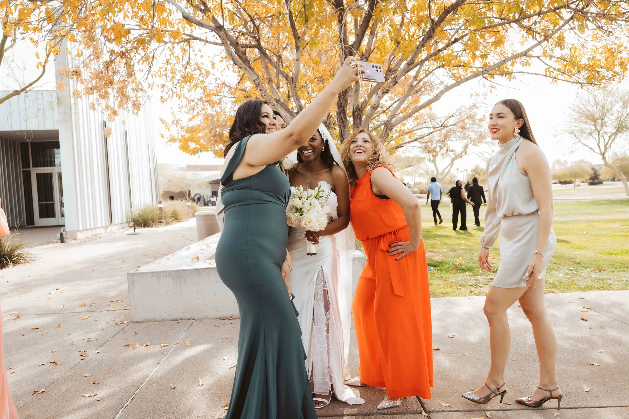 Bride taking a selfie with friends after wedding ceremony