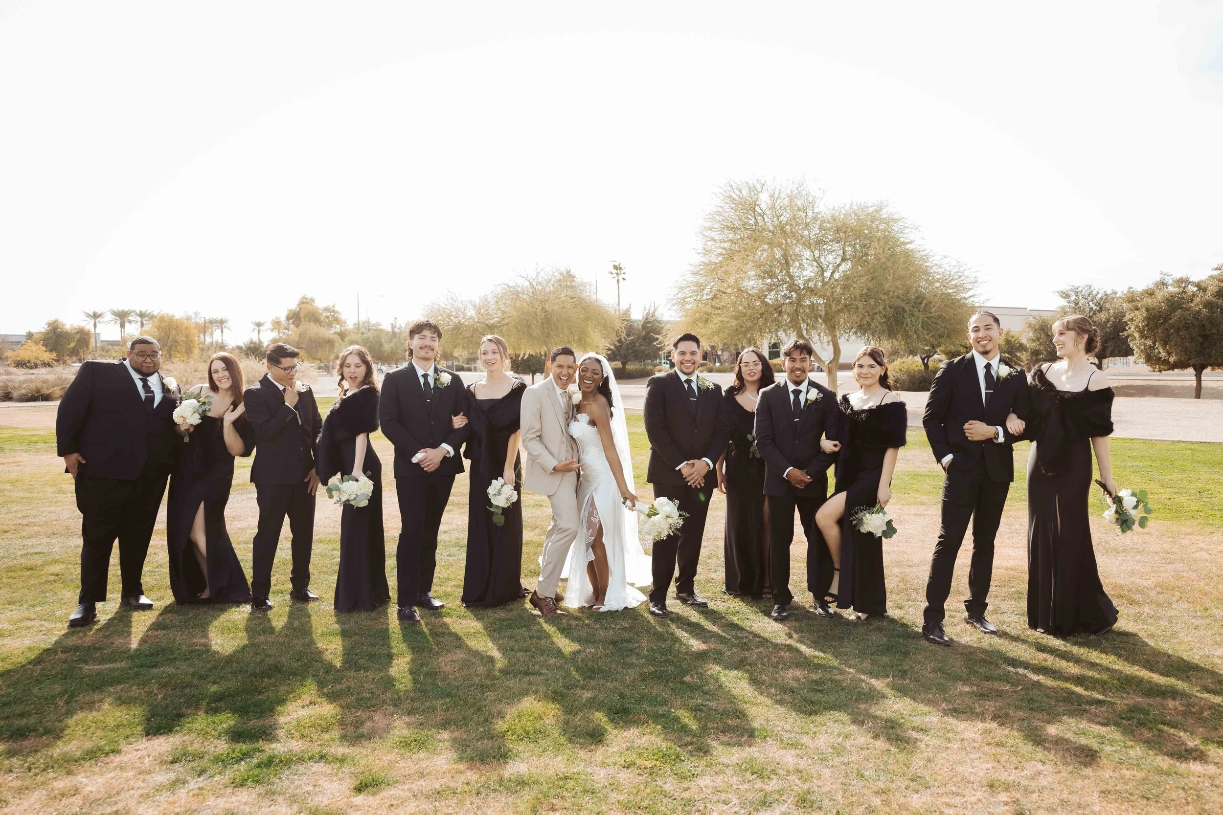 Wedding party laughing together during group photos