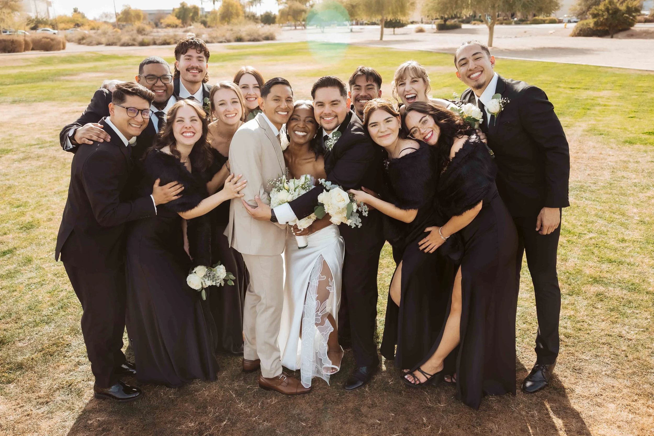 Jade and Abel celebrating with their wedding party in Gilbert