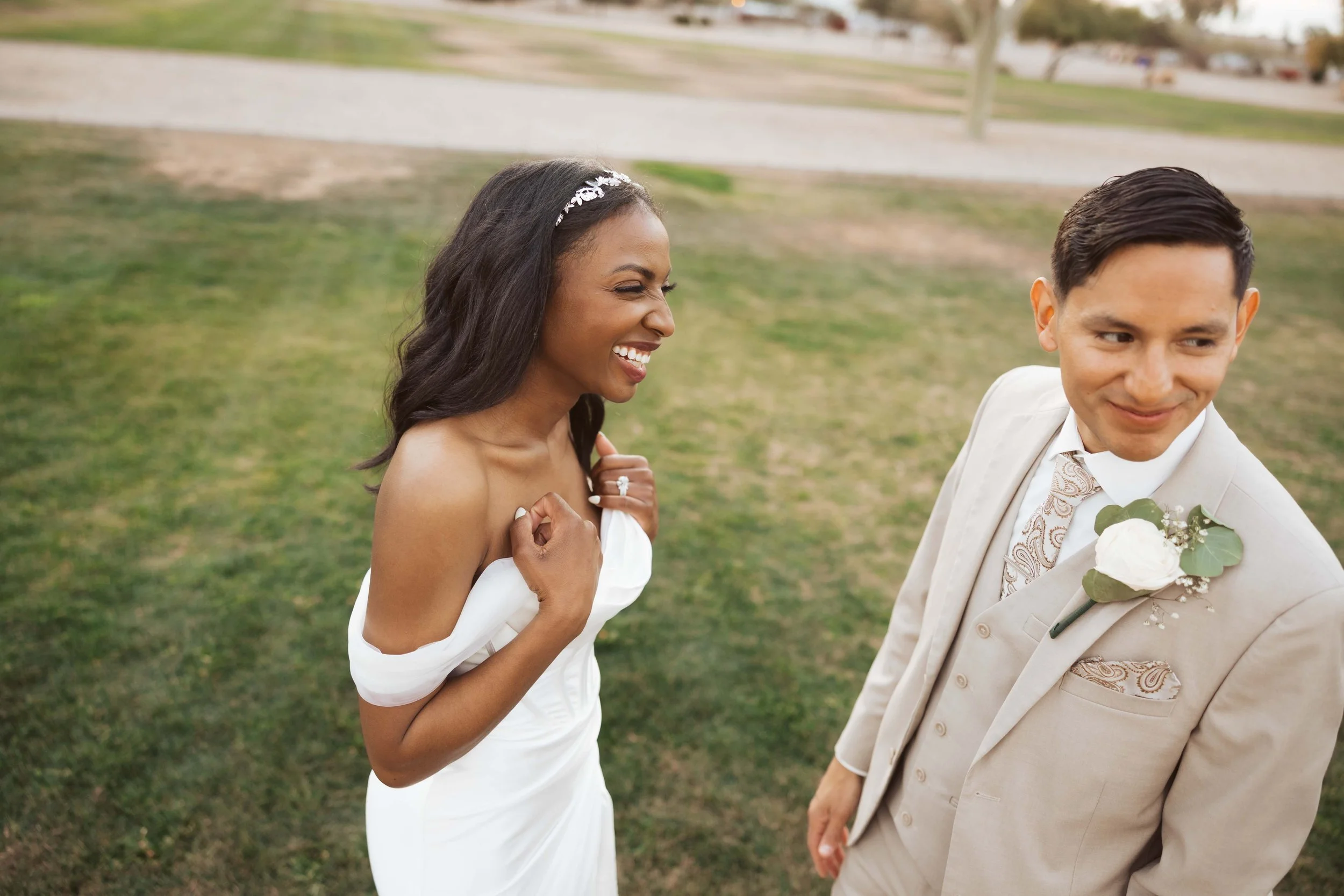 Bride laughing at groom during sunset photos in gilbert