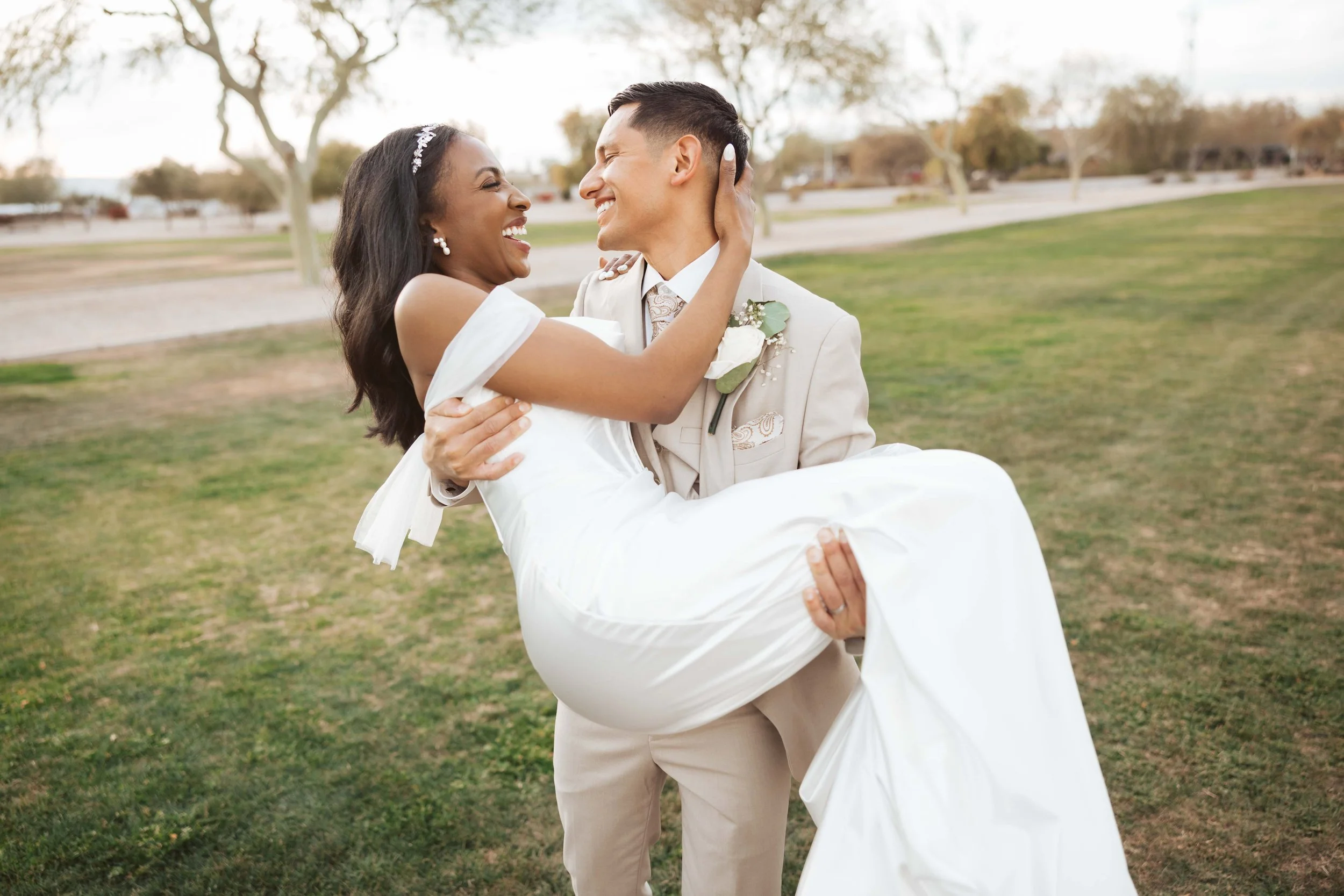 Groom holding bride during sunset photos in gilbert