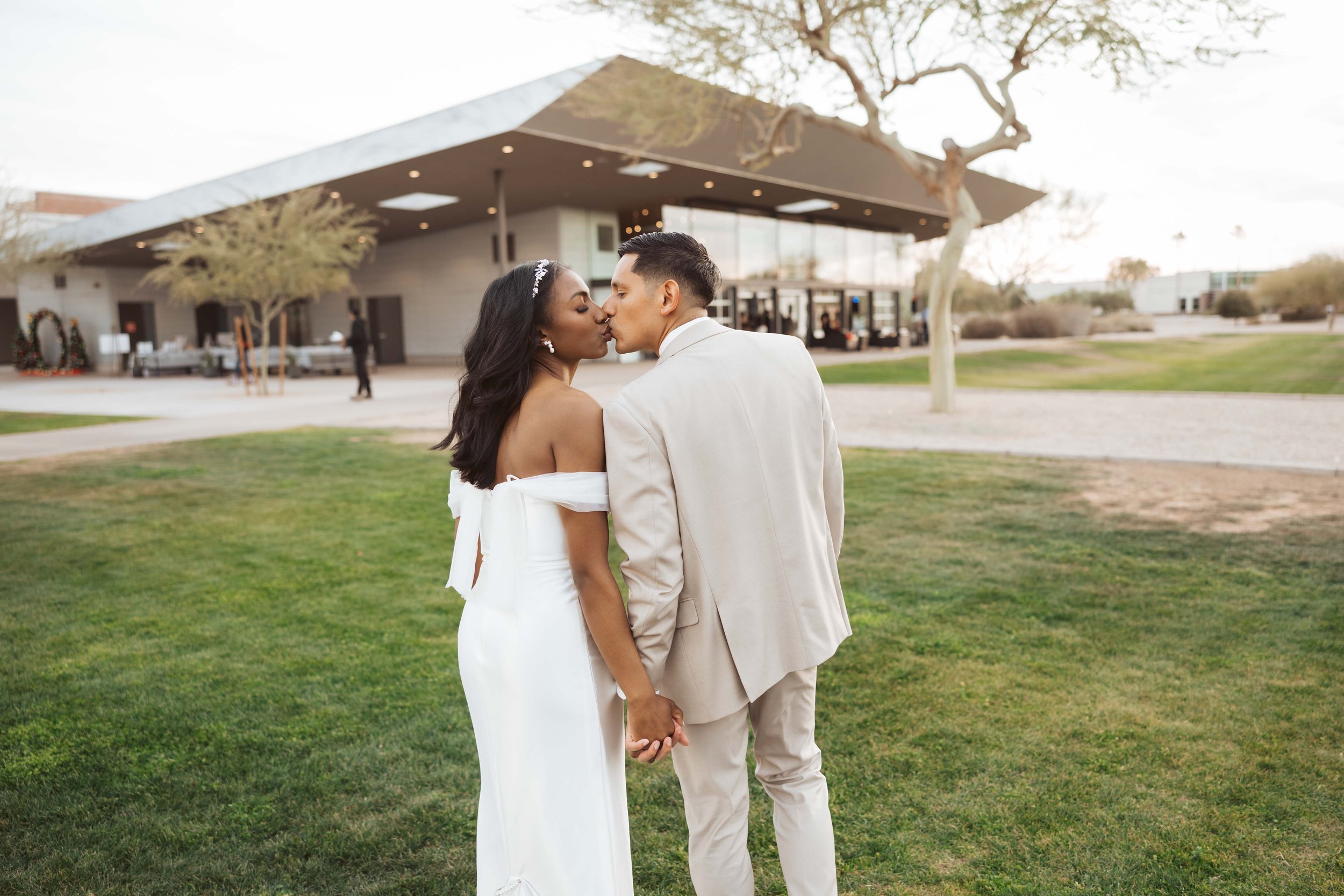 Couple kissing during sunset photos at Redemption Gilbert