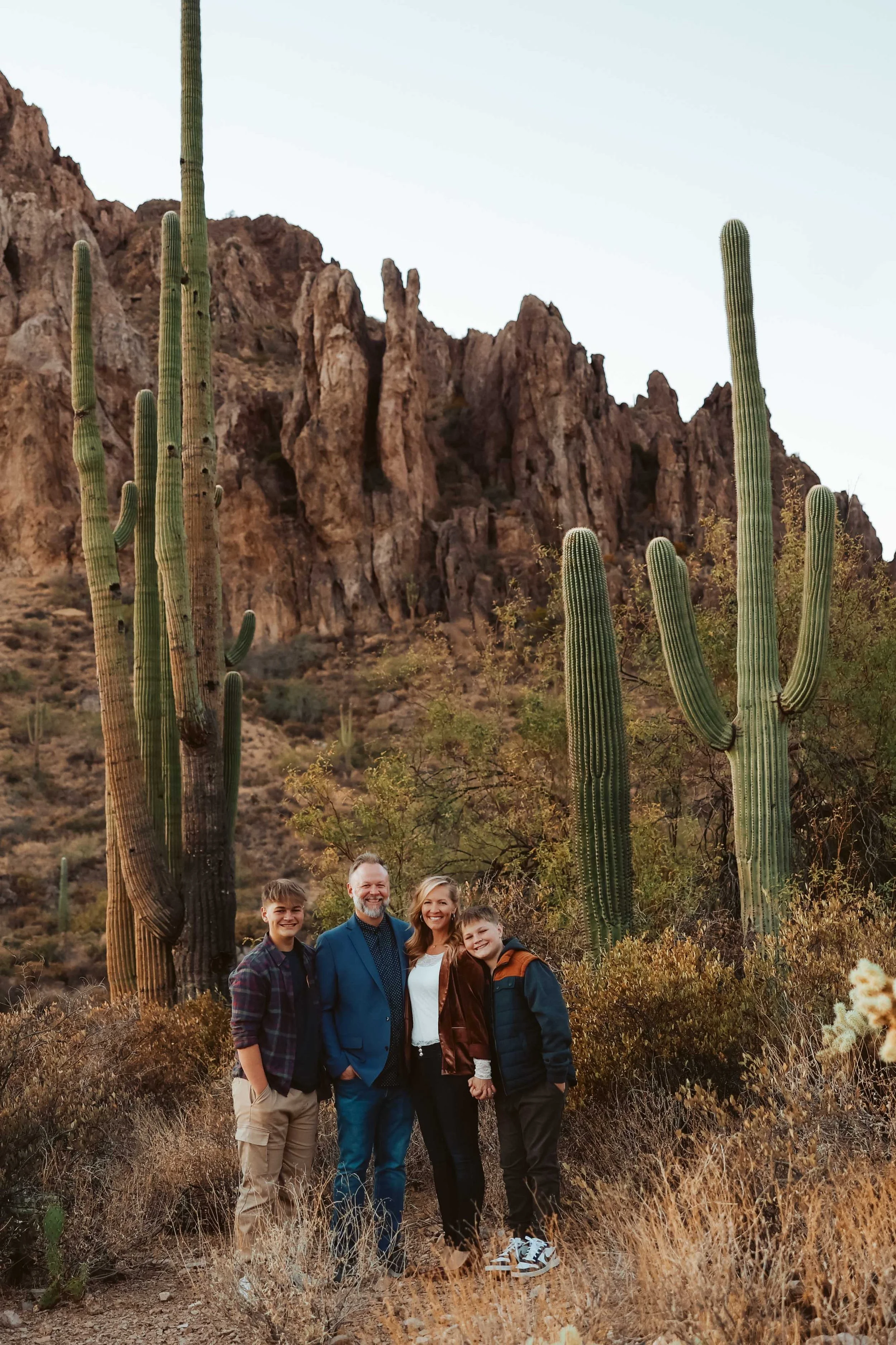 family of four surrounded by cactus in the superstition mountians