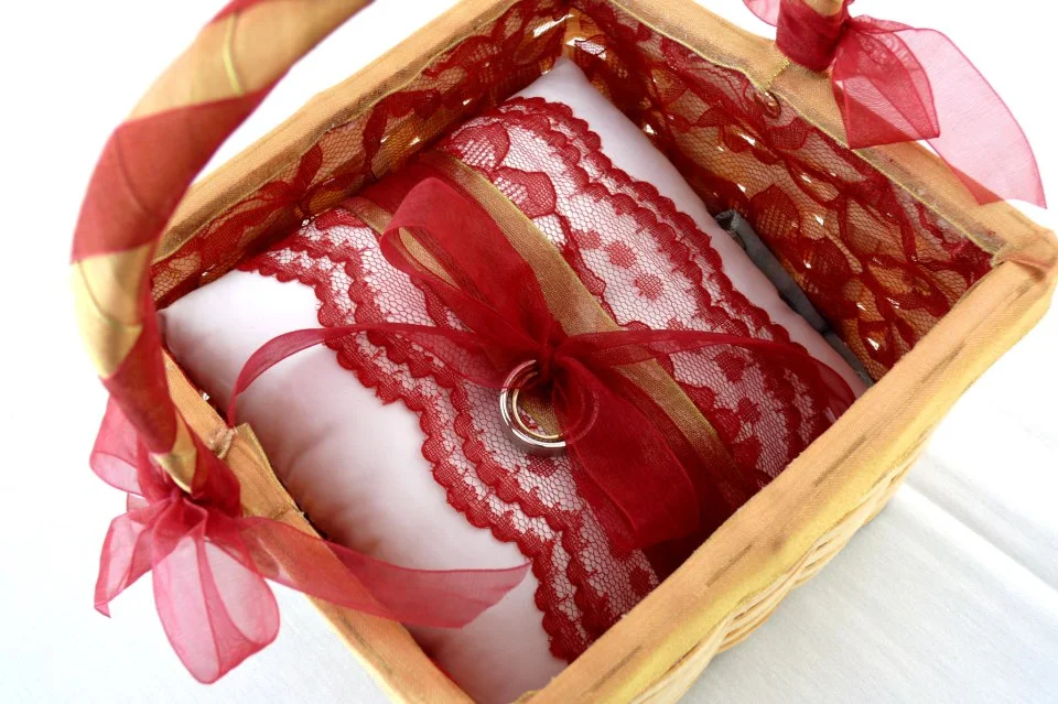 Flower girl basket + ring bearer pillow adorned with satin, lace + ribbons.