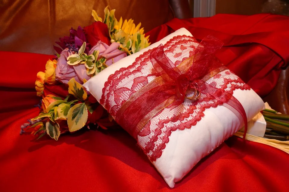 Ring bearer pillow adorned with satin, lace + ribbons.