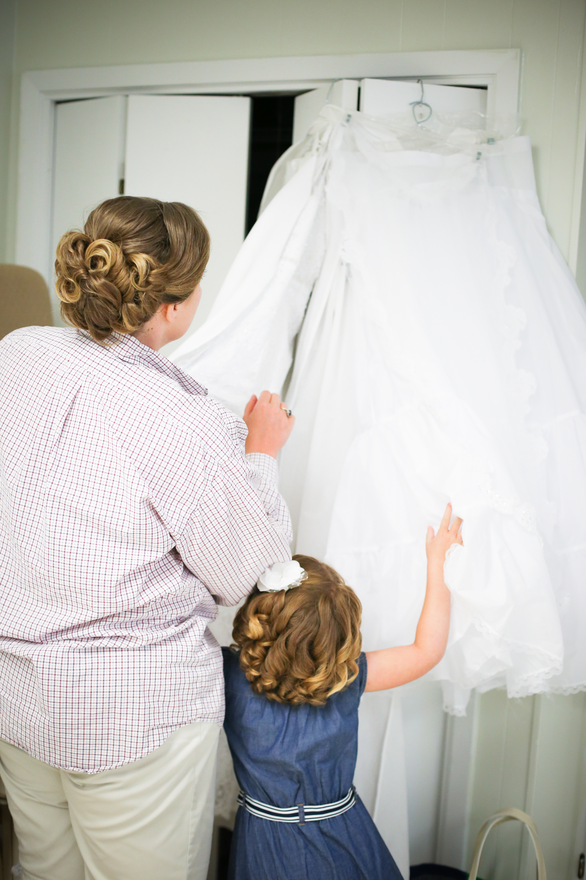 Amanda & her new daughter looking on in awe at Amanda's beautiful gown. 
