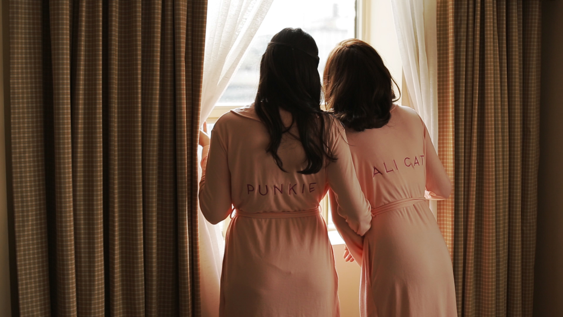 Bridemaids looking out a window