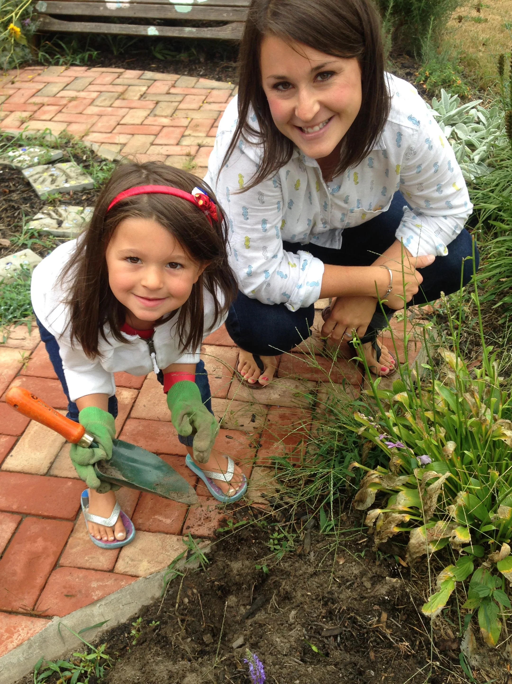 Mrs. Pollina and Alexa work in the Centennial Garden