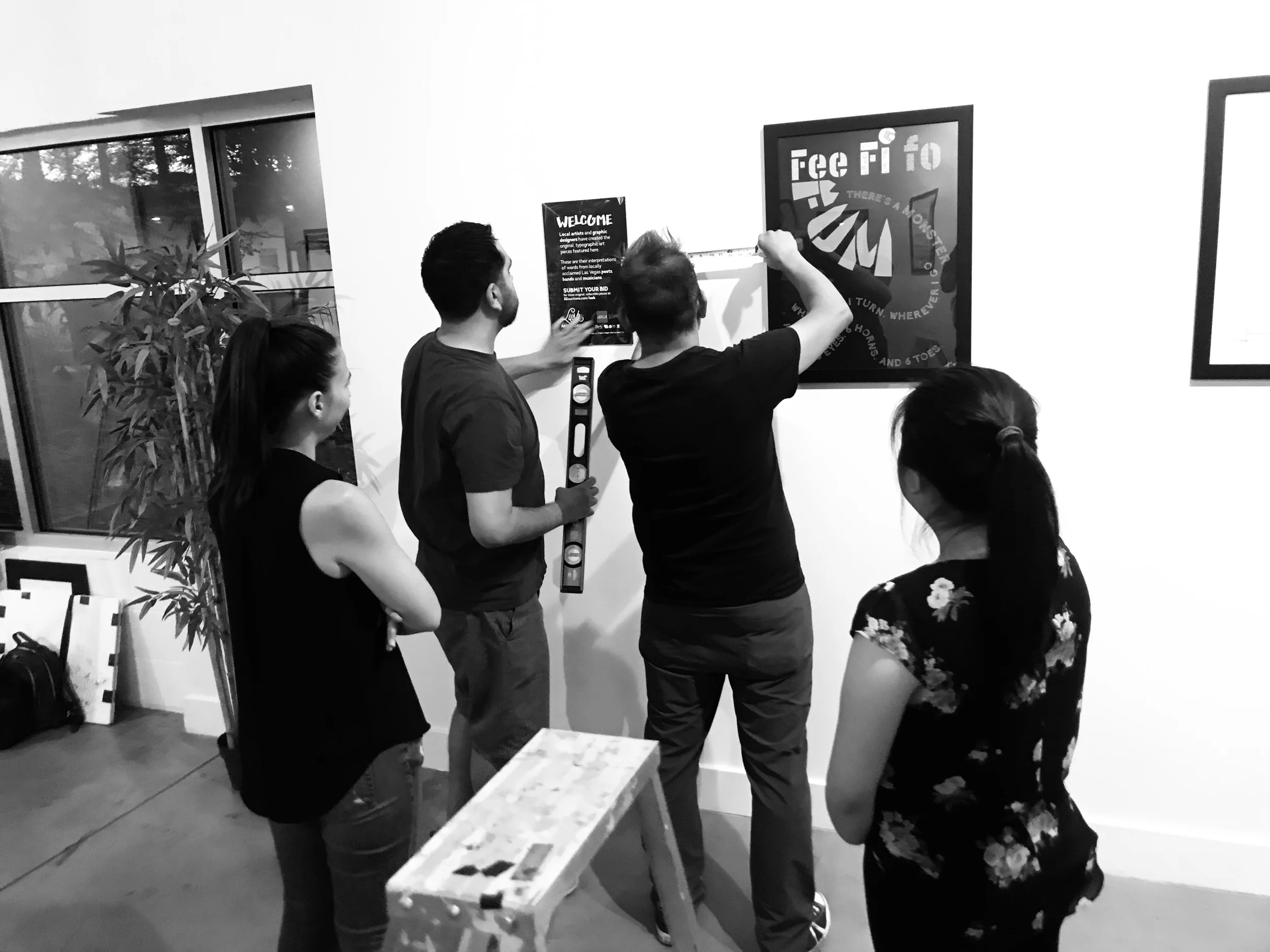 AIGA LV Board of Directors Jennie Marsh, Juan Beltran, AIGA Program Director and Editor In Chief of VIM Magazine Jorge Lara, and Therese Bautista setting up at Escape Artist Studios.