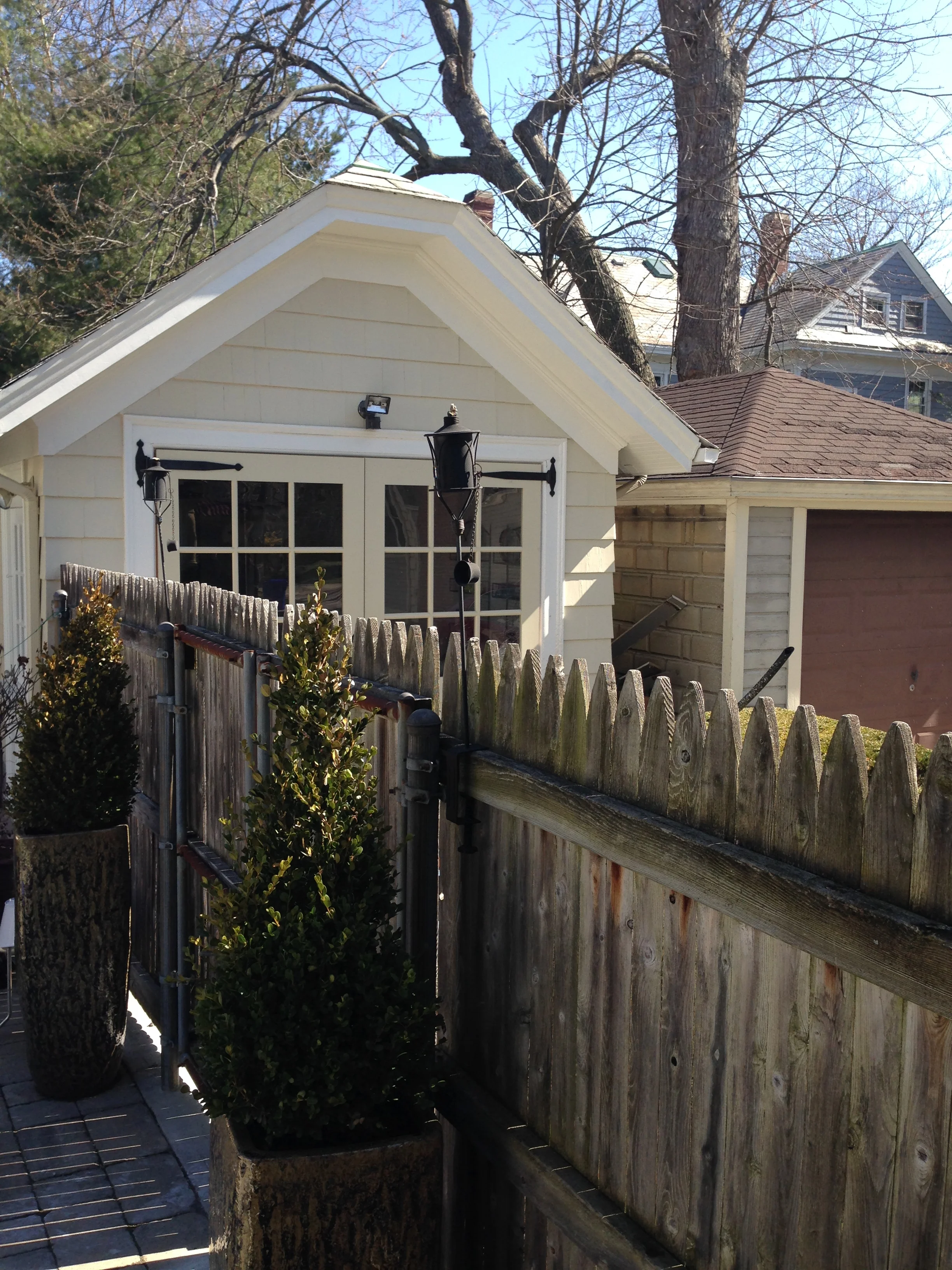 This fence eventually came down to reveal the new pool house / gym and to accommodate an outdoor dining room.