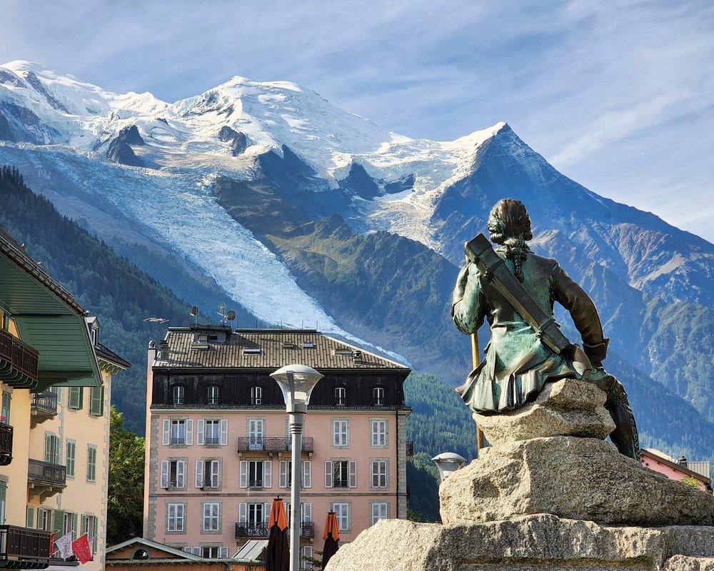 A statue of Michel Paccard overlooking Mont Blanc from Chamonix Town Center.