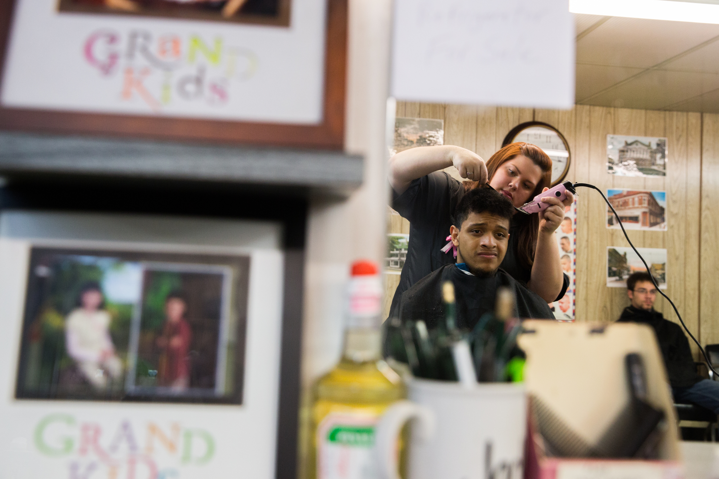 Francisco Garcia of Mt. Blue Middle School, gets a hair cut by Lacey Savage at the Broadway Barbershop on a freezing day in January in Farmington, Maine.