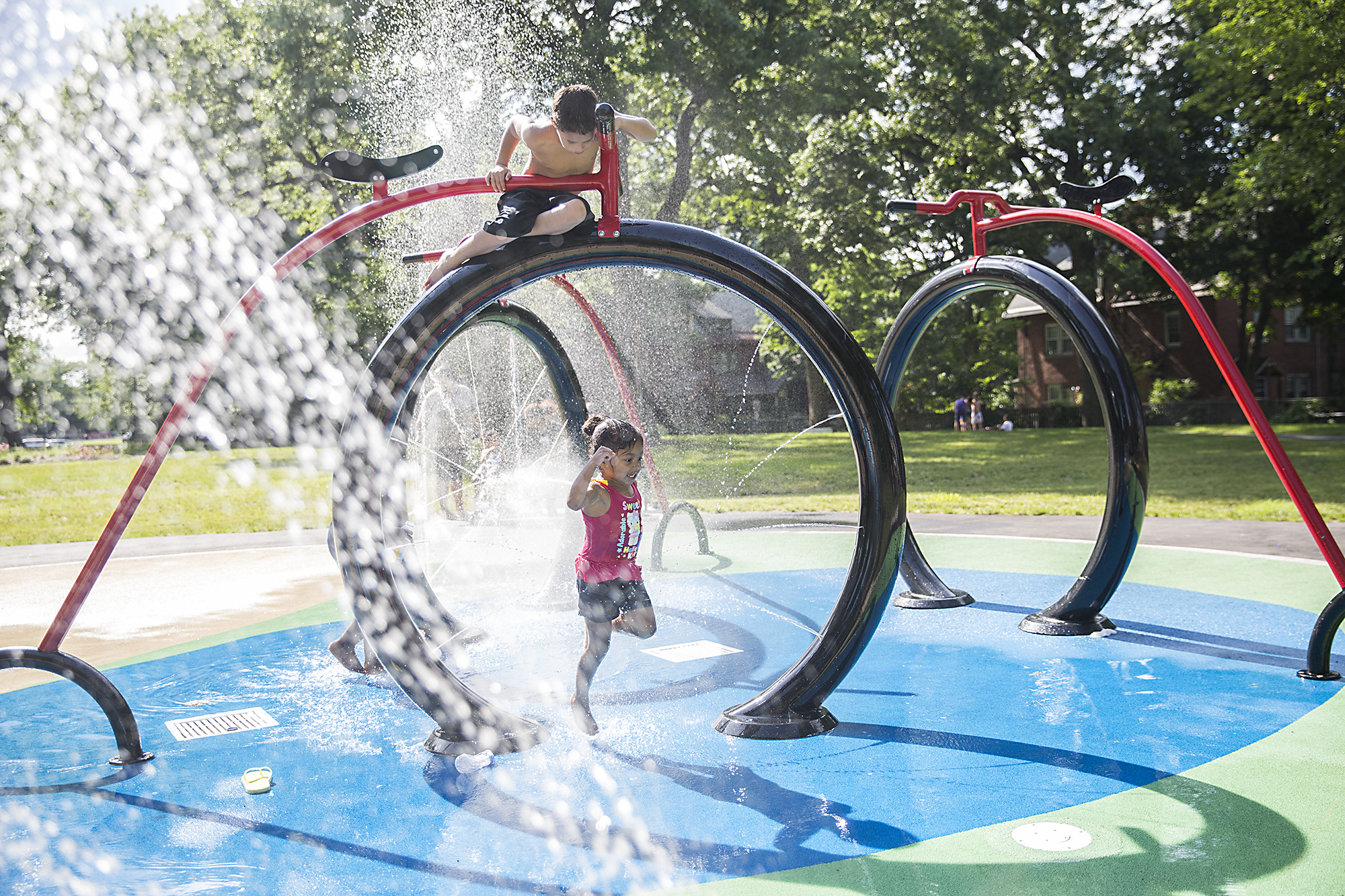 Kids play in the sprinklers in Baby Pope Park in Hartford, CT in the 80 degree weather on Monday June 22.
