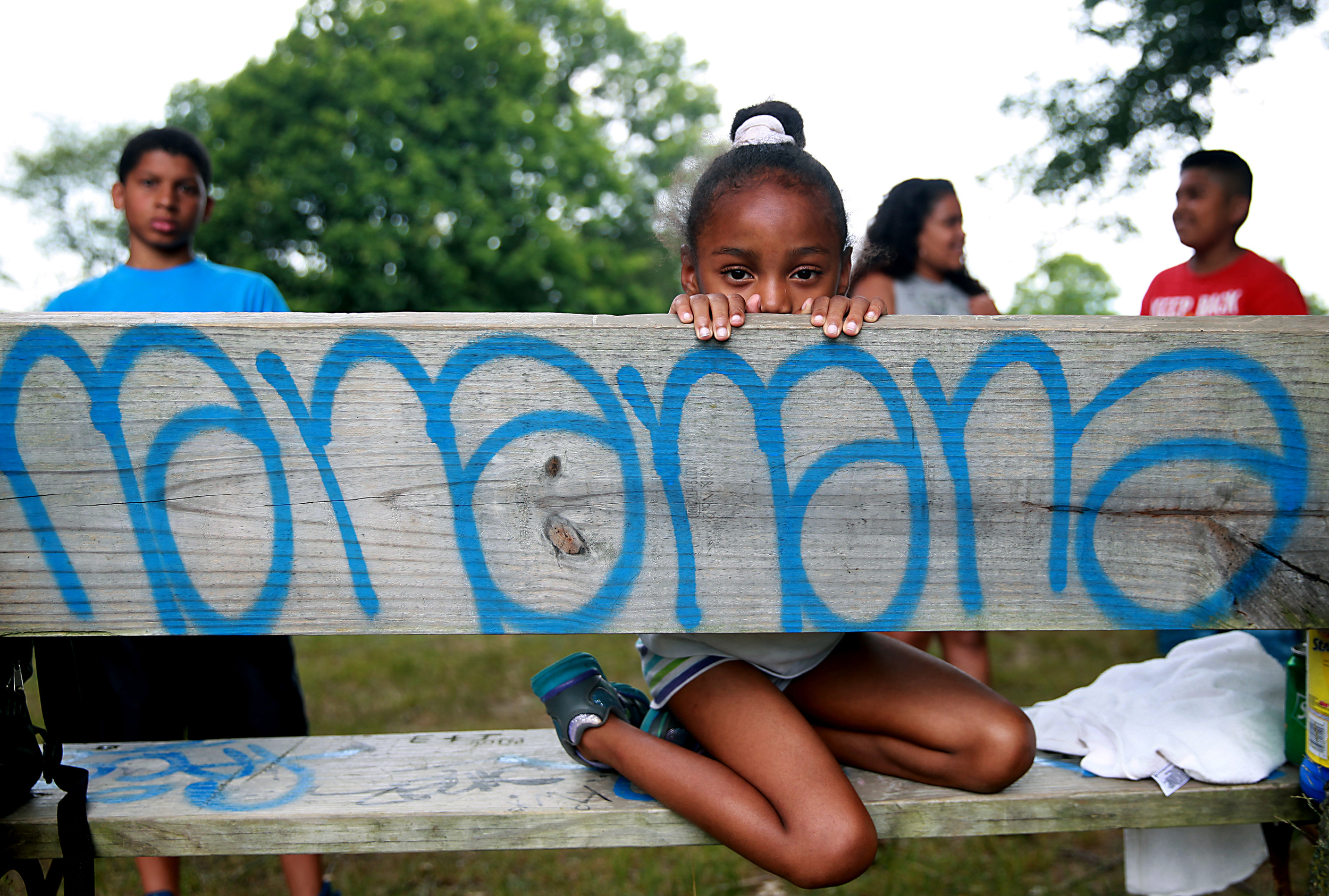 Navaho Washington, 7, of the Hartford Neighborhood Center's Camp Hi Hoti, relaxes in Pope Park between playtime and lunch. Camp Hi Hoti offers an educational and recreational outdoor experience geared to enhance the overall development of a child.