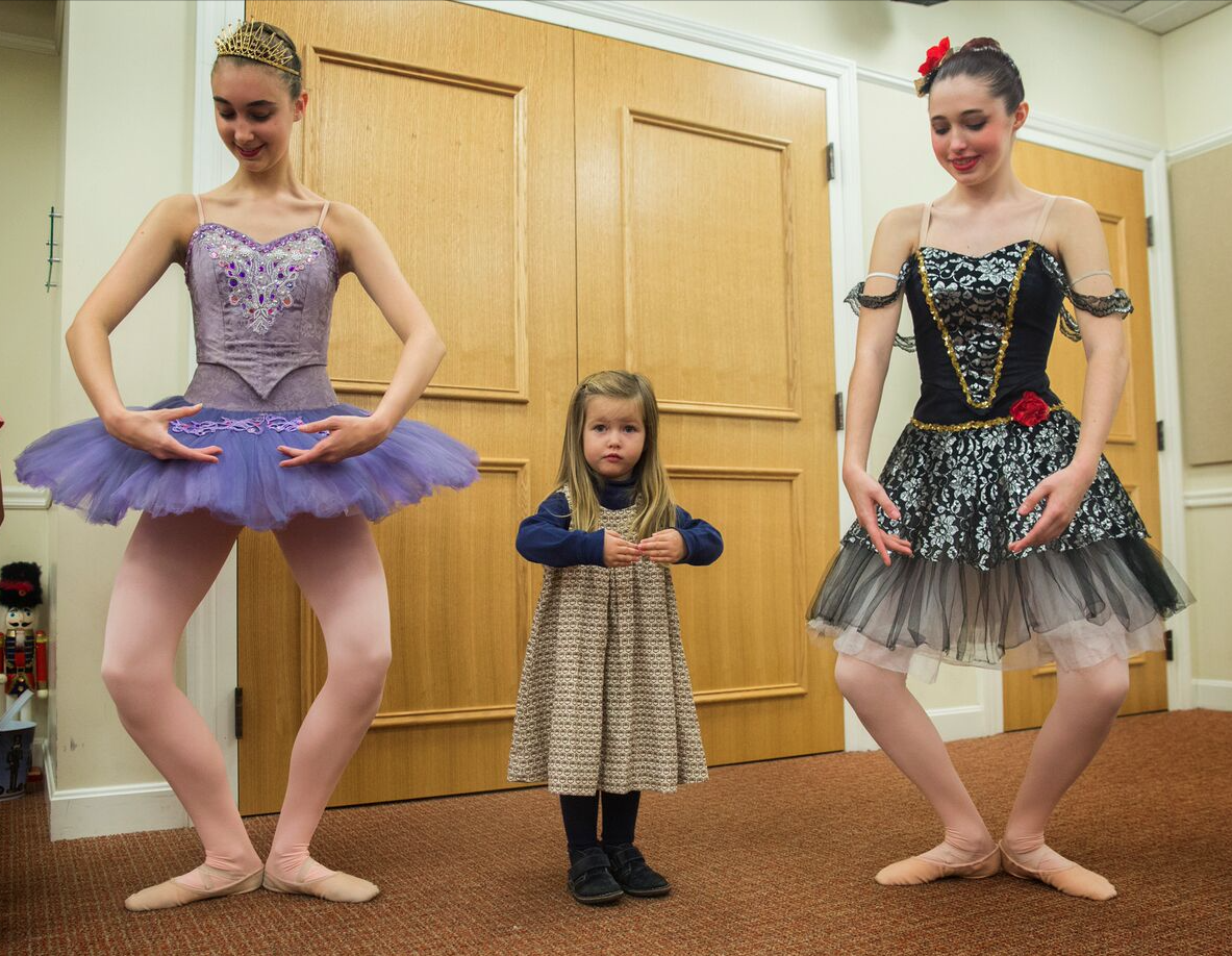 Alicia Haynes, 15, of Glastonbury (left) and Dakota Jusem-Laporte, 14, of Manchester (right) of the Connecticut Concert Ballet helped Dale Duvall, 3, of West Hartford, learn ballet positions, after they preformed The Nutcracker at the West Hartford Library on Monday . "It's fun to get them moving instead of just being in the audience," said Wendy Fish-Lawrence one of the Connecticut Concert Ballet's artistic directors. 