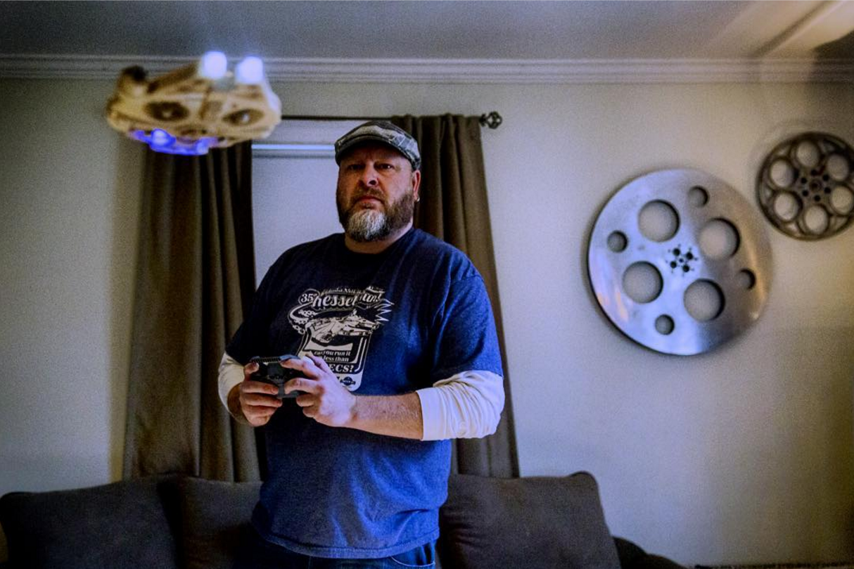 Jared Brodeur, of Enfield, Ct. flies a miniature Millennium Falcon drone in his living room.