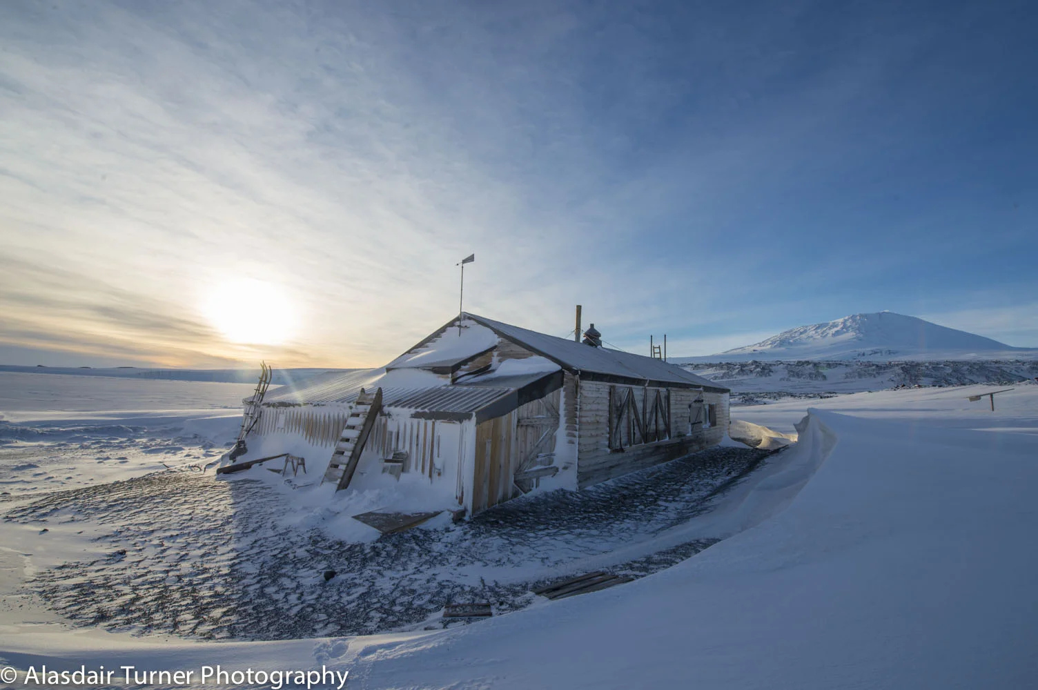 Sunset over Robert Falcon Scott's Terra Nova hut at Cape Evans, Antarctica.