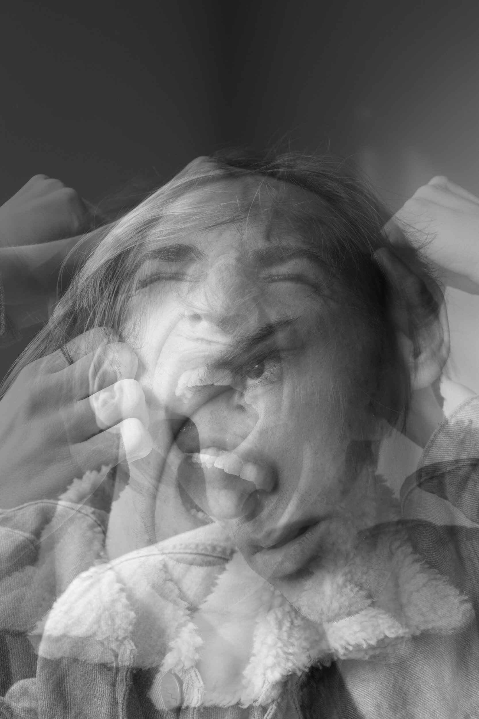 Black-and-White Thinking: a black and white image of several images of a woman in distressed superimposed over one another.