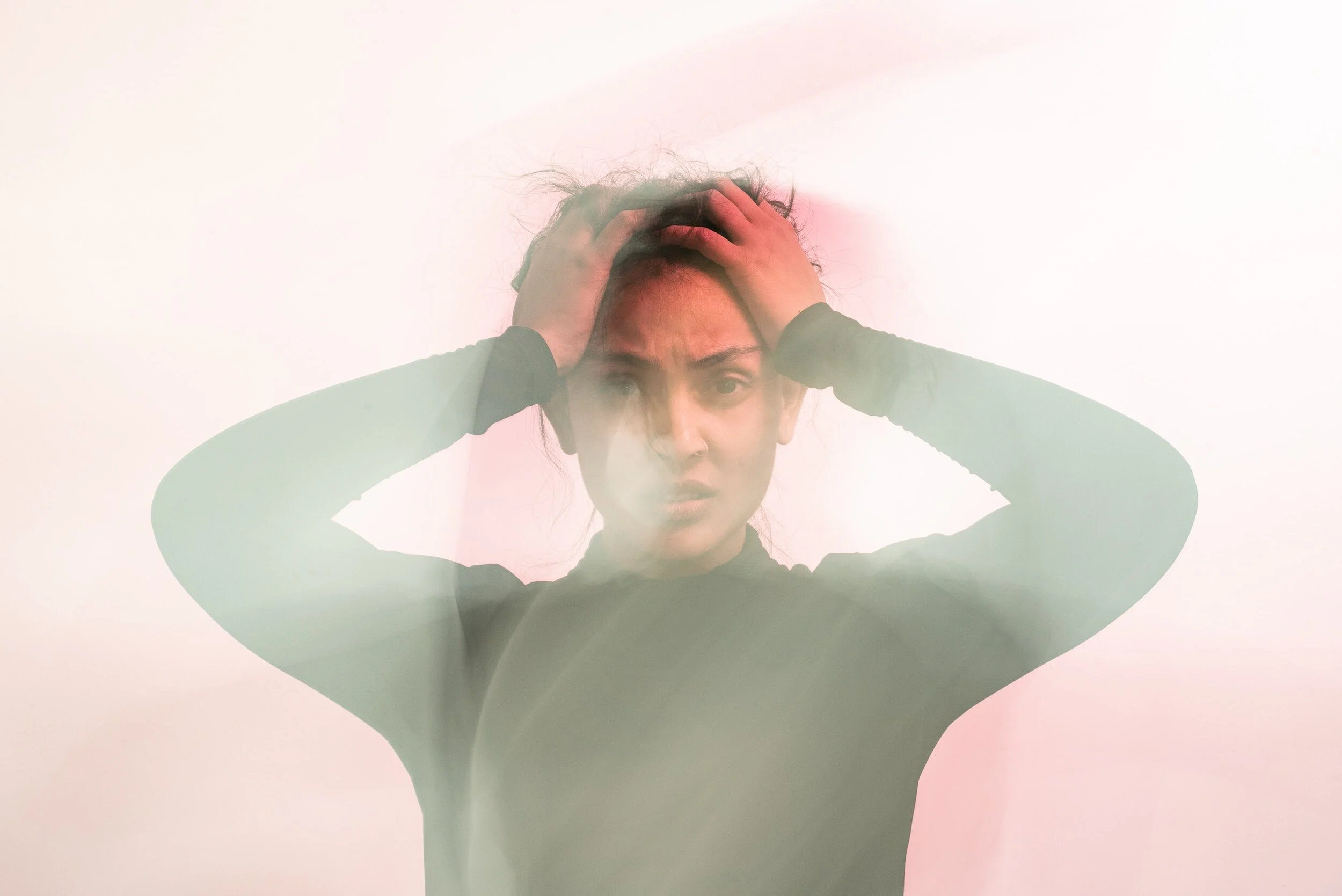 How to Stop Ruminating: person with OCD looking exasperated, head in hands