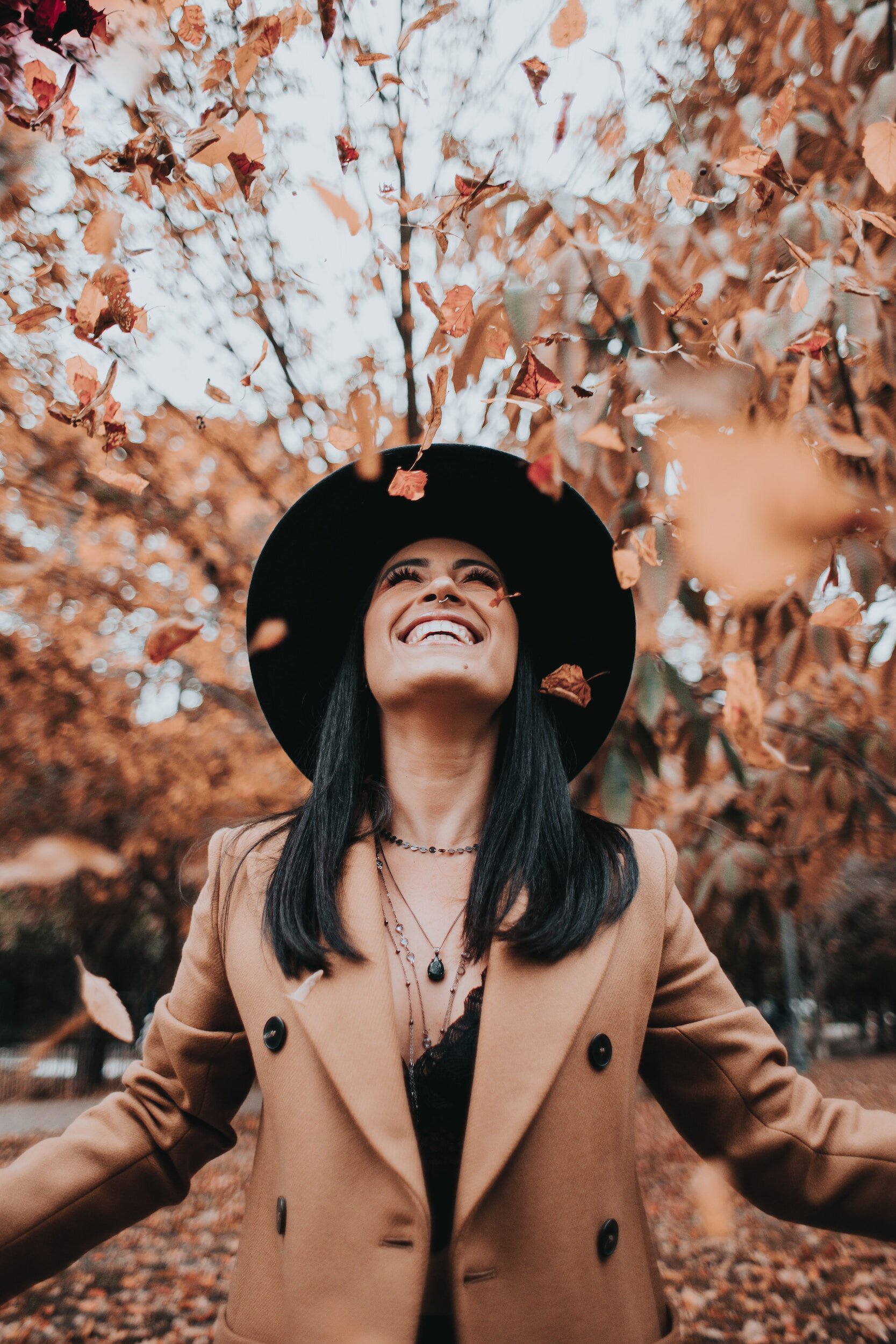 woman free of rumination, laughing and looking up at the sky