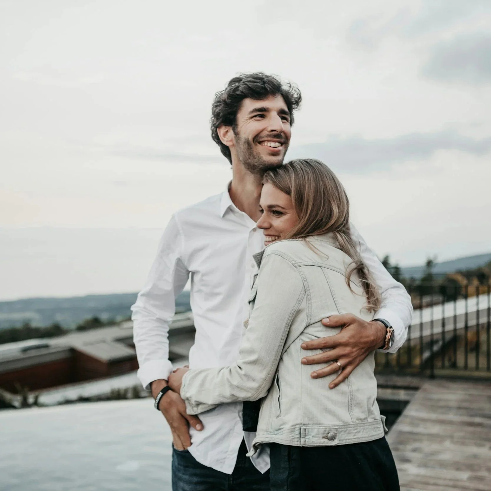 A man and woman holding one another