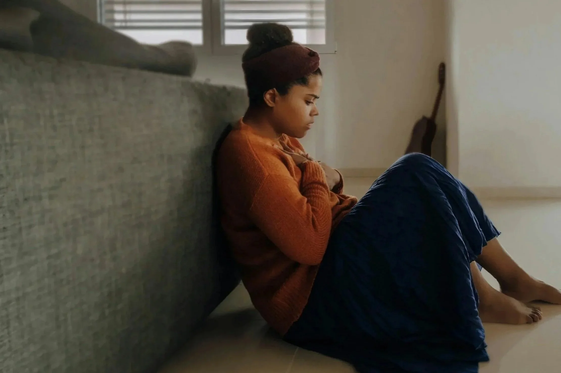 CBT for Panic Disorder: Woman sitting on the floor curled up having a panic attack.