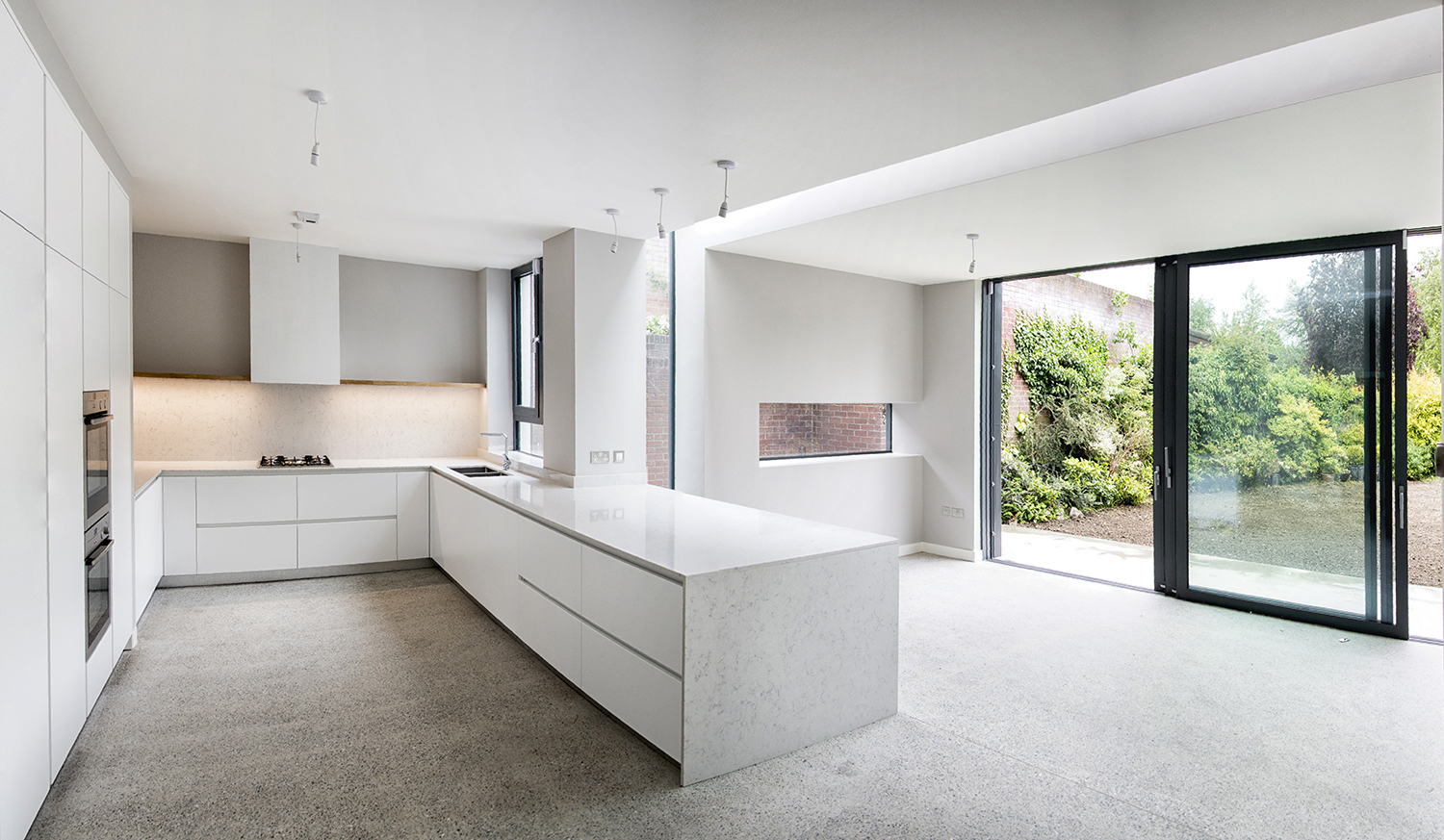 Kitchen and extension with triple sliding doors to garden