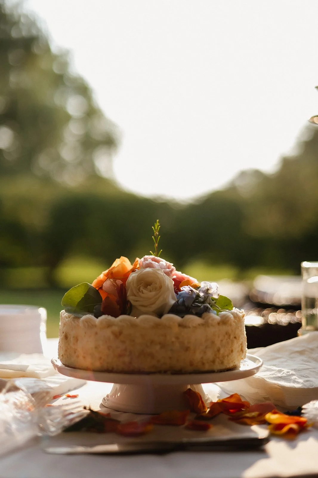 Cake with flowers on top on an outdoor table
